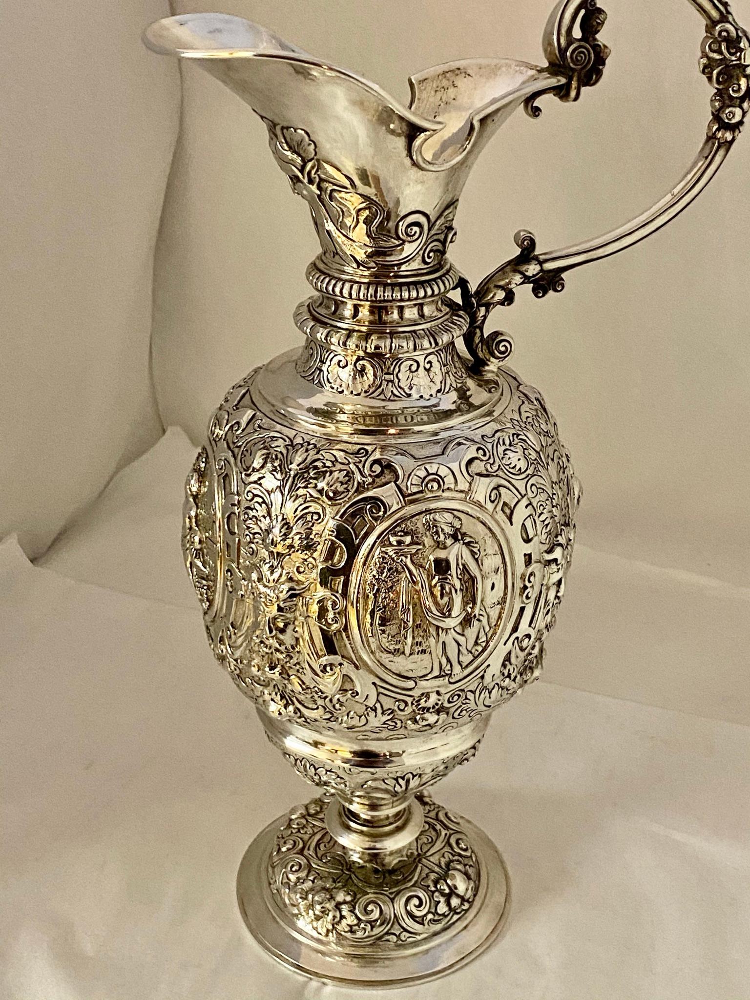 A silver Baroque pitcher,
Silver content 780/000 (12.5 Lötig)
Fully hand-hammered motifs of floral leaves and cartouches with mytholochic figures. (Copy after 16th century pitcher)
This technique was a specialty of silver smiths from Hanau (near