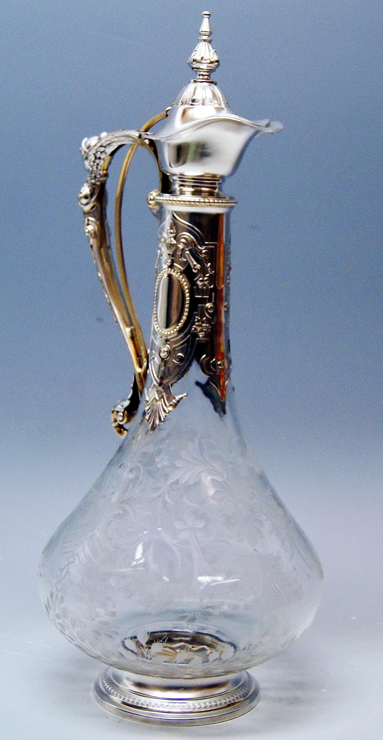 Glass decanter (wine carafe) with silver mountings made during period of Historicism.
Hallmarked:
-- SILVER 800 AUSTRIAN HALLMARK = symbol of wing with sign 4W

Made circa 1880-1890

Specifications:
The decanter's form is pear - shaped;  the