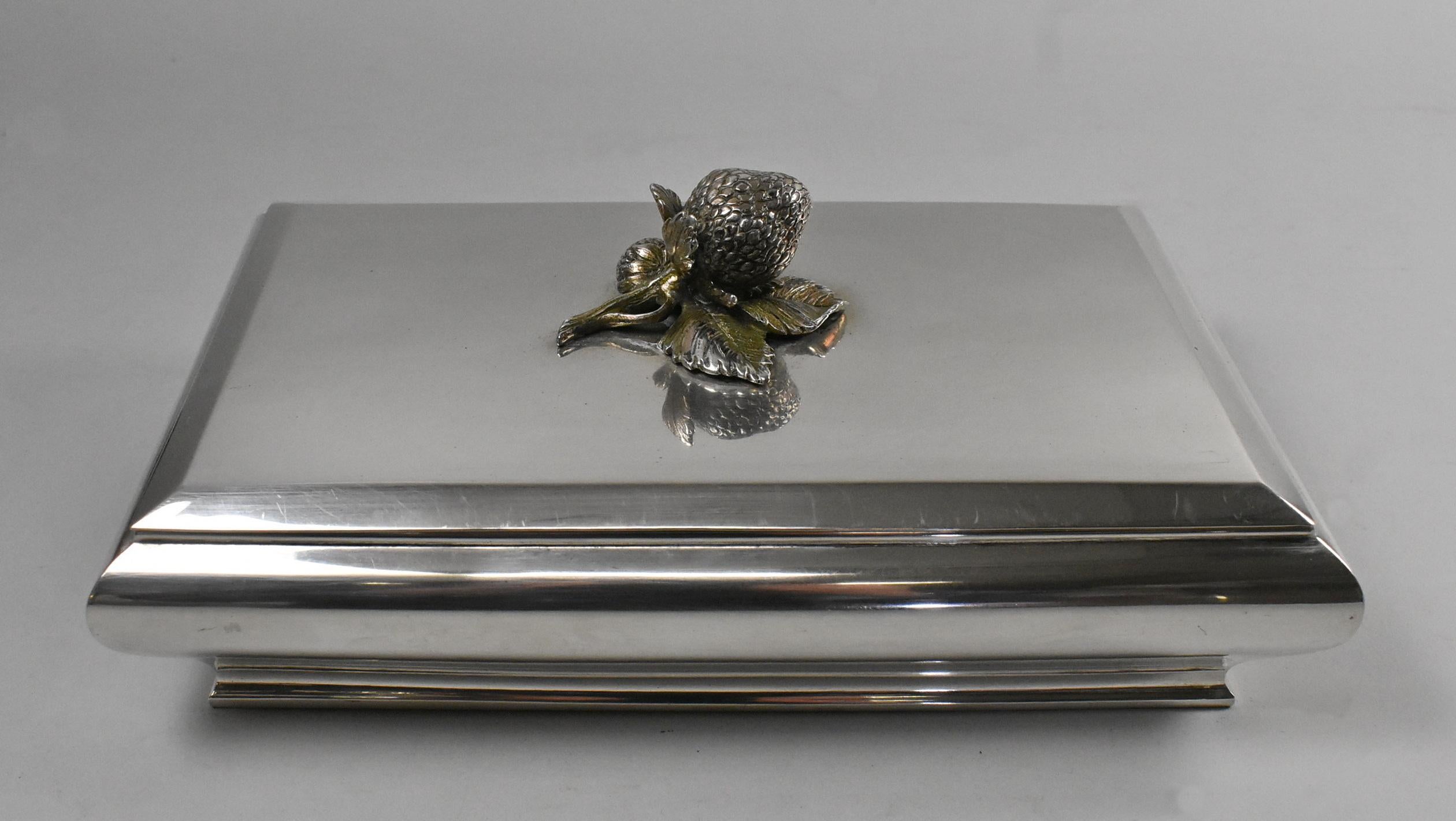 Silver 800 strawberry lidded vanity box. 1090.6 grams in weight. Very light scratches to surface. Dimensions: 6.25