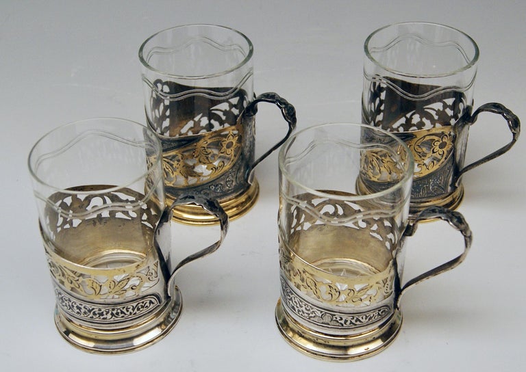 Silver set of four tea glasses / Russian, made in Moscow.
Dating: 20th century / made circa 1958-1965 
Material: solid silver 875 and glass

Hallmarked: 
Russian Official Silver Stamp = Star with Hammer and Sickle (= used as from the year 1958)