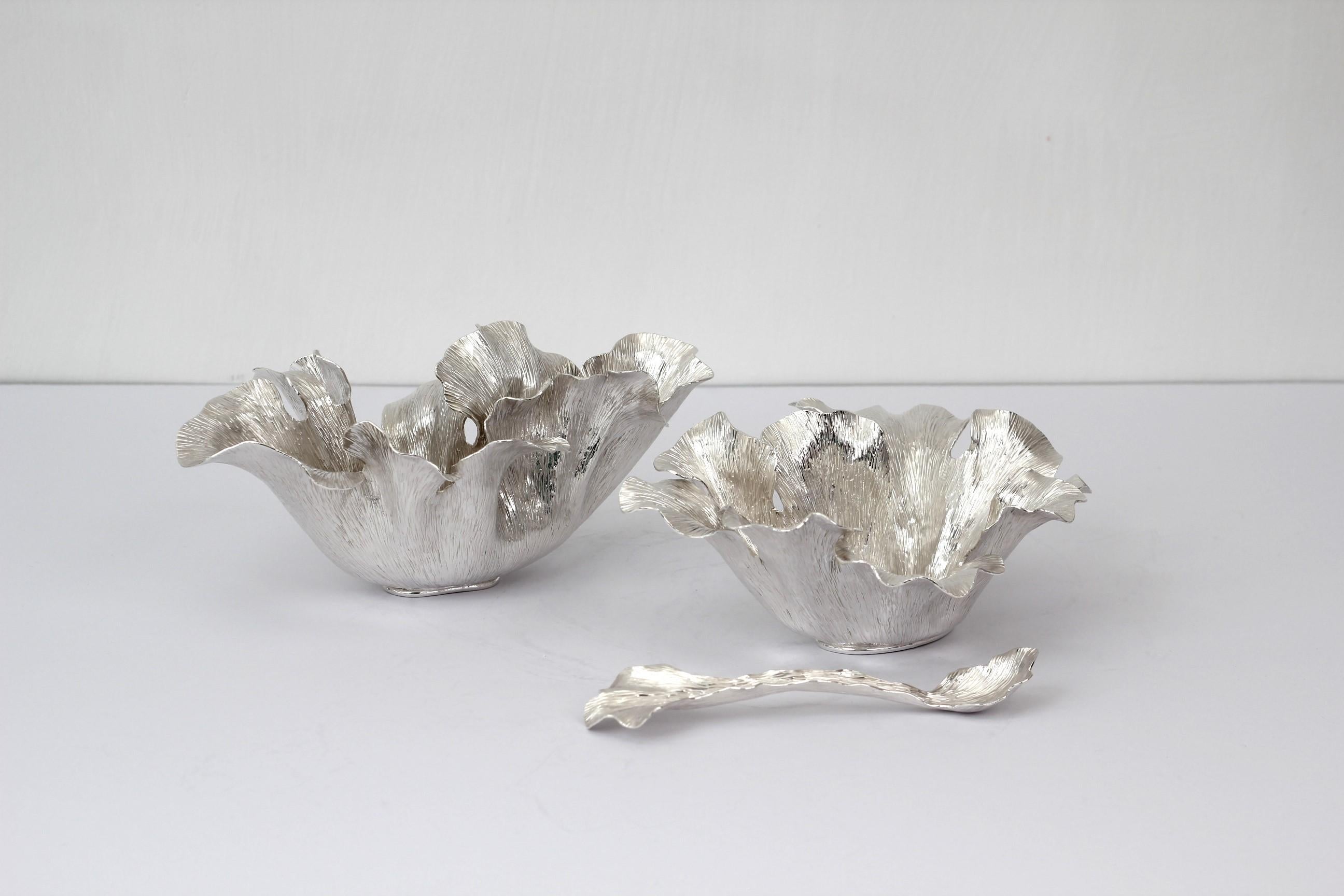 Inspired by the movement and flow of the sea anemone, this organic creamer and sugar set is made out of Silver .950

100% hand made by expert craftsmen, each sheet of metal is hand hammered, cut and bent using metal and wood as a last to give each