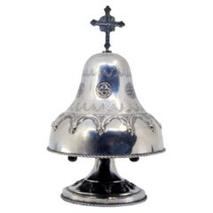 Silver altar bell w/ bows, cords & topped w/ a radiant cross, mechanism inside