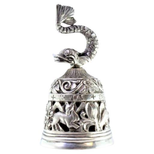 Silver altar bell with cut-out reliefs and dolphin-shaped knob