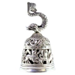 Silver altar bell with cut-out reliefs and dolphin-shaped knob