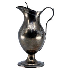 Silver altar wine cruet with floral engraving and beaded base