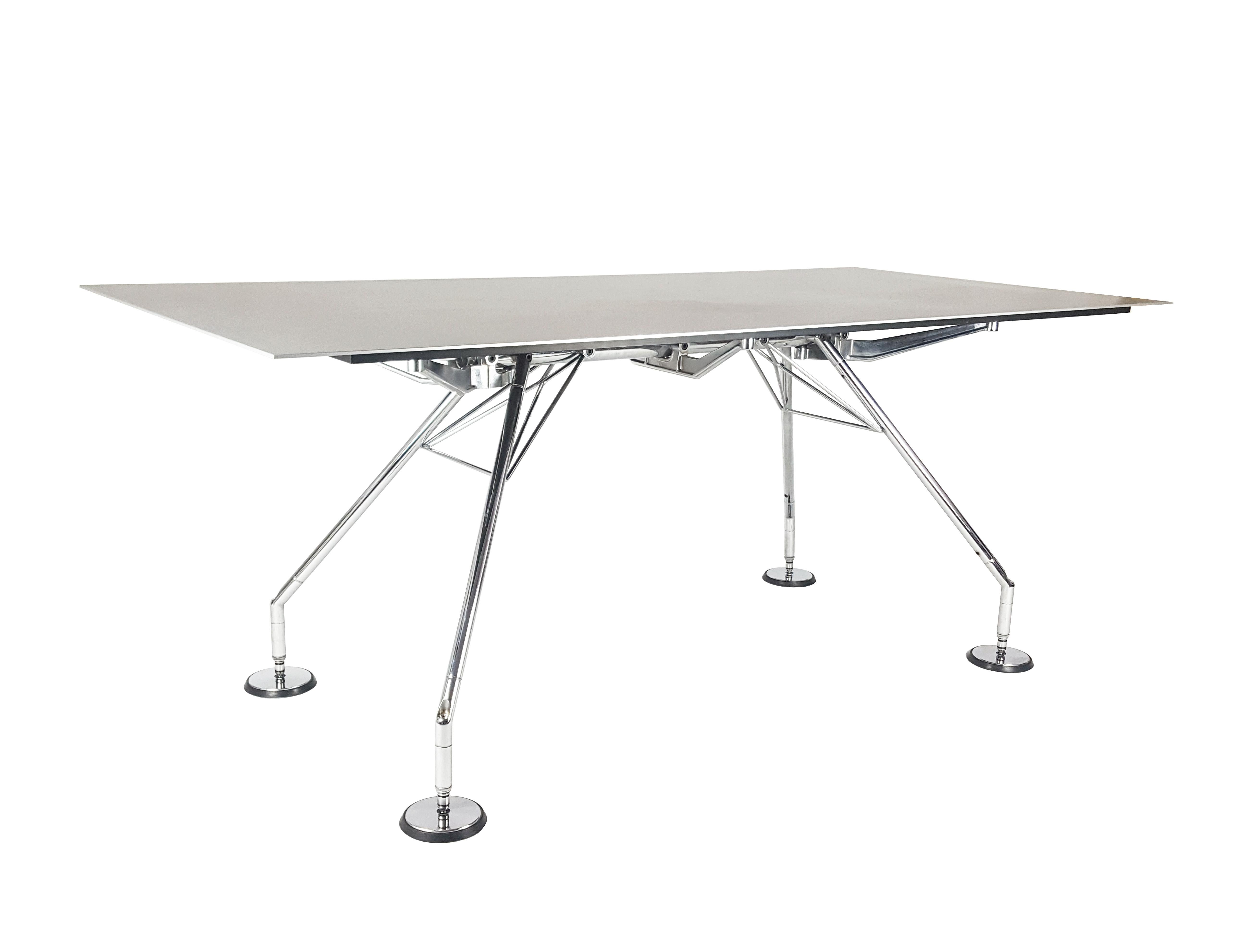 This nomos table or desk was designed by Norman Foster in the 1980s. This version belongs to a later production, (1990-2000). Rare version with a silver aluminum tabletop (rough finish skin). Legs are made from chrome-plated metal with black