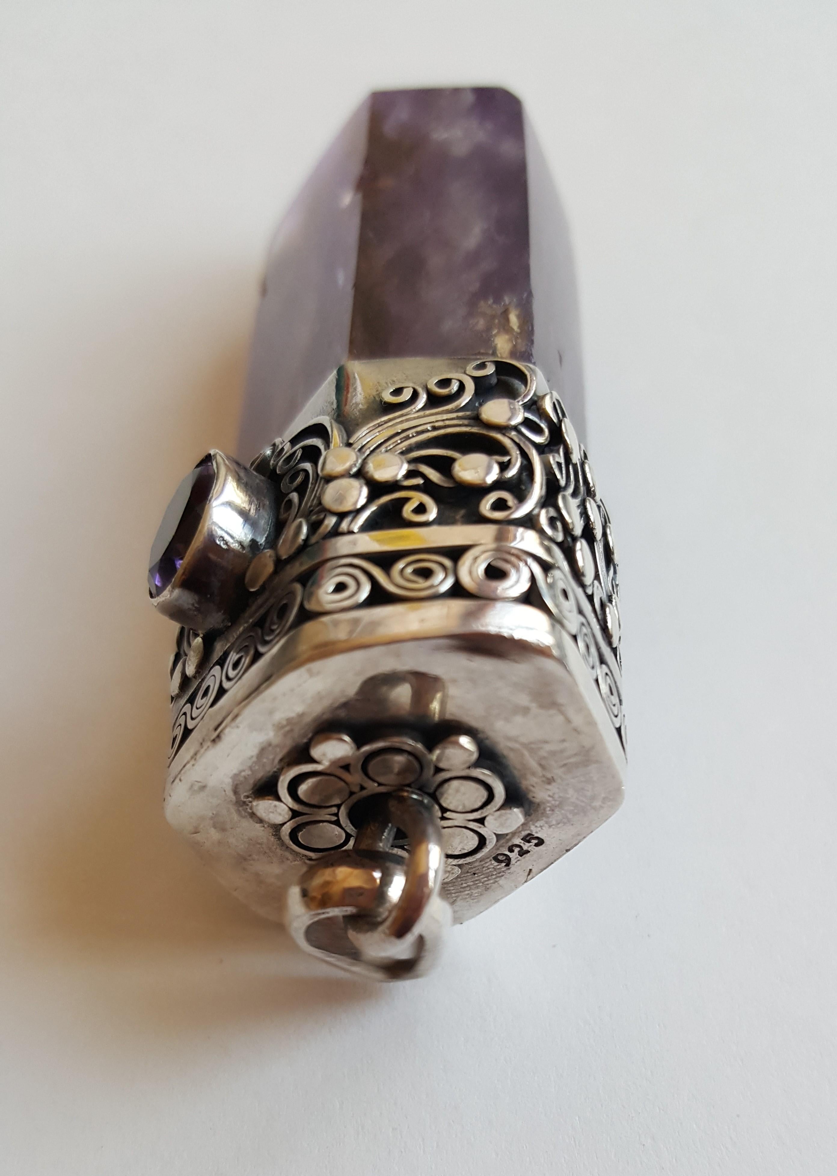 Ornate silver hand fabricated design and bail holding a rich purple polish amethyst stone. This piece is large and can be used at a pendant, The top bail has a beautifully fabricated design and it's stamped 925. Amethyst is believe to give off an