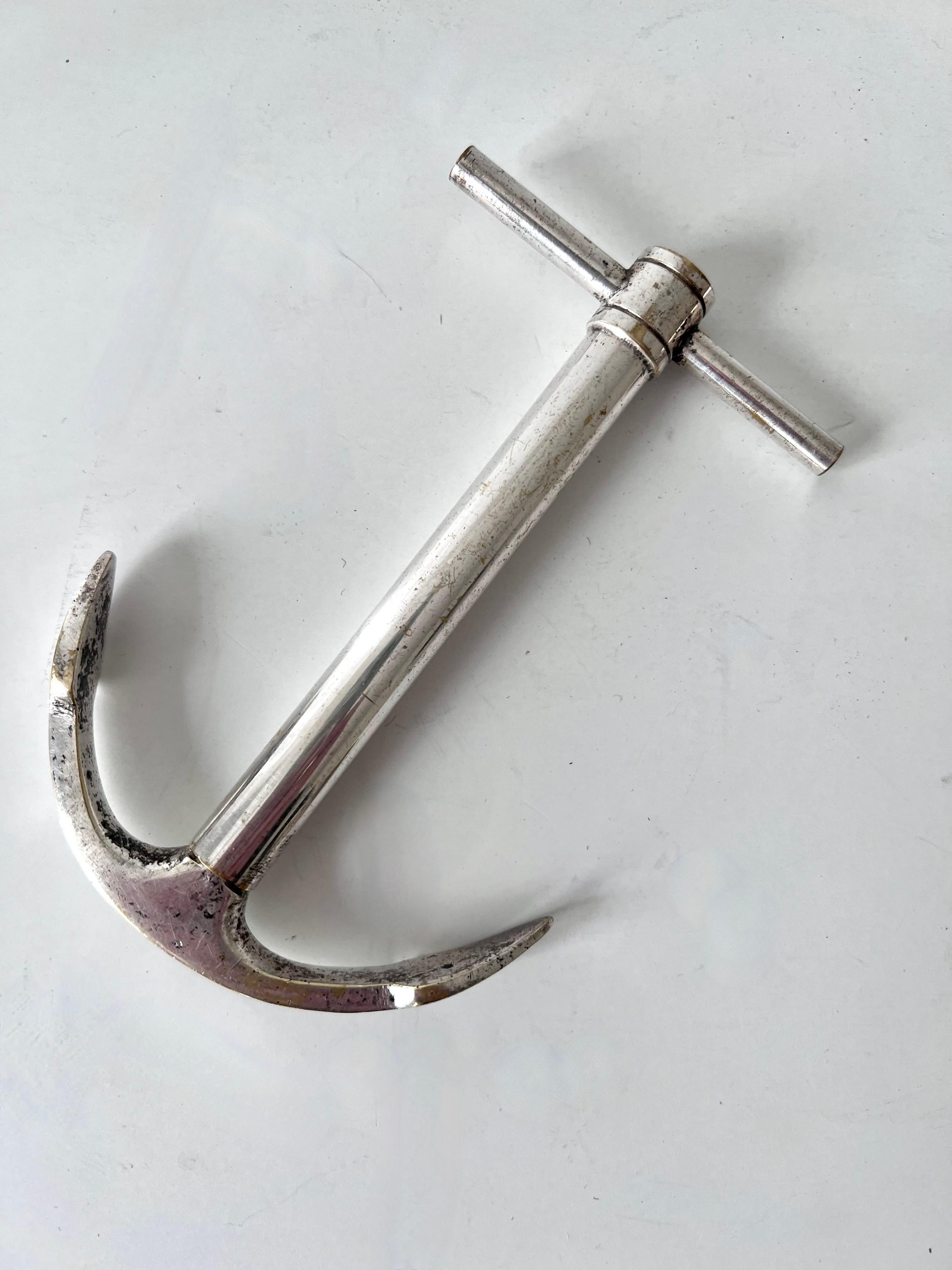 A unique bottle opener from Paris France, the piece is an anchor when closed, but when pulled apart becomes a corkscrew. A compliment to many bars, especially those near or with a seaside theme.