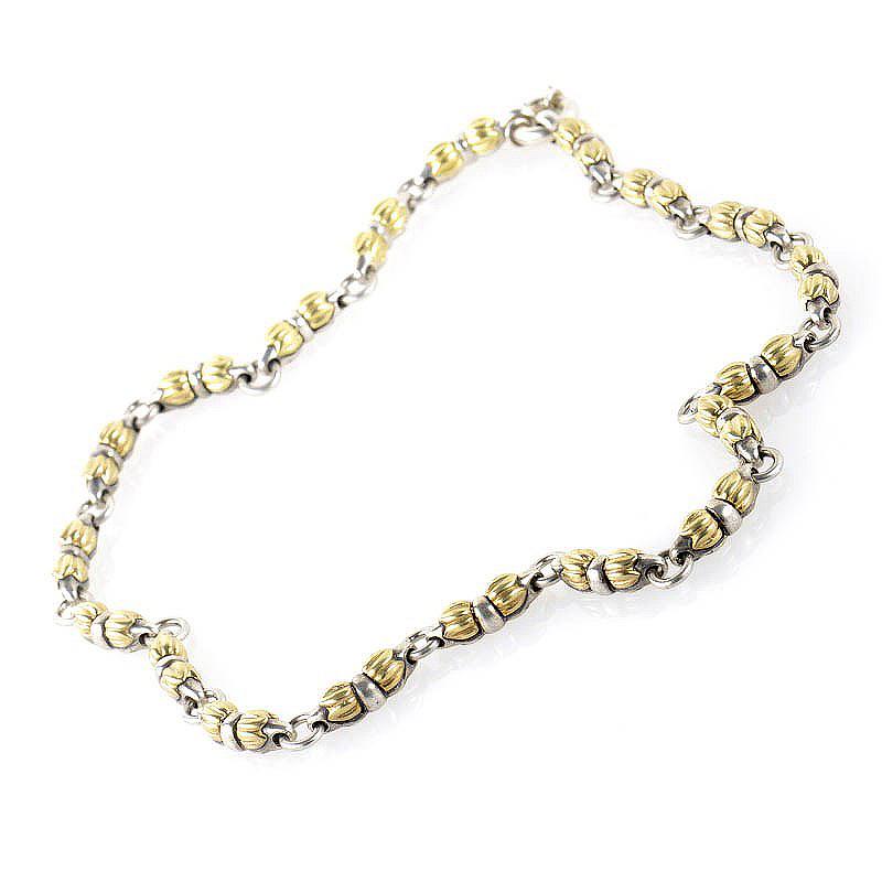 This necklace is is simple and sophisticated. It is made of 18K yellow gold and silver links which connect the beads.