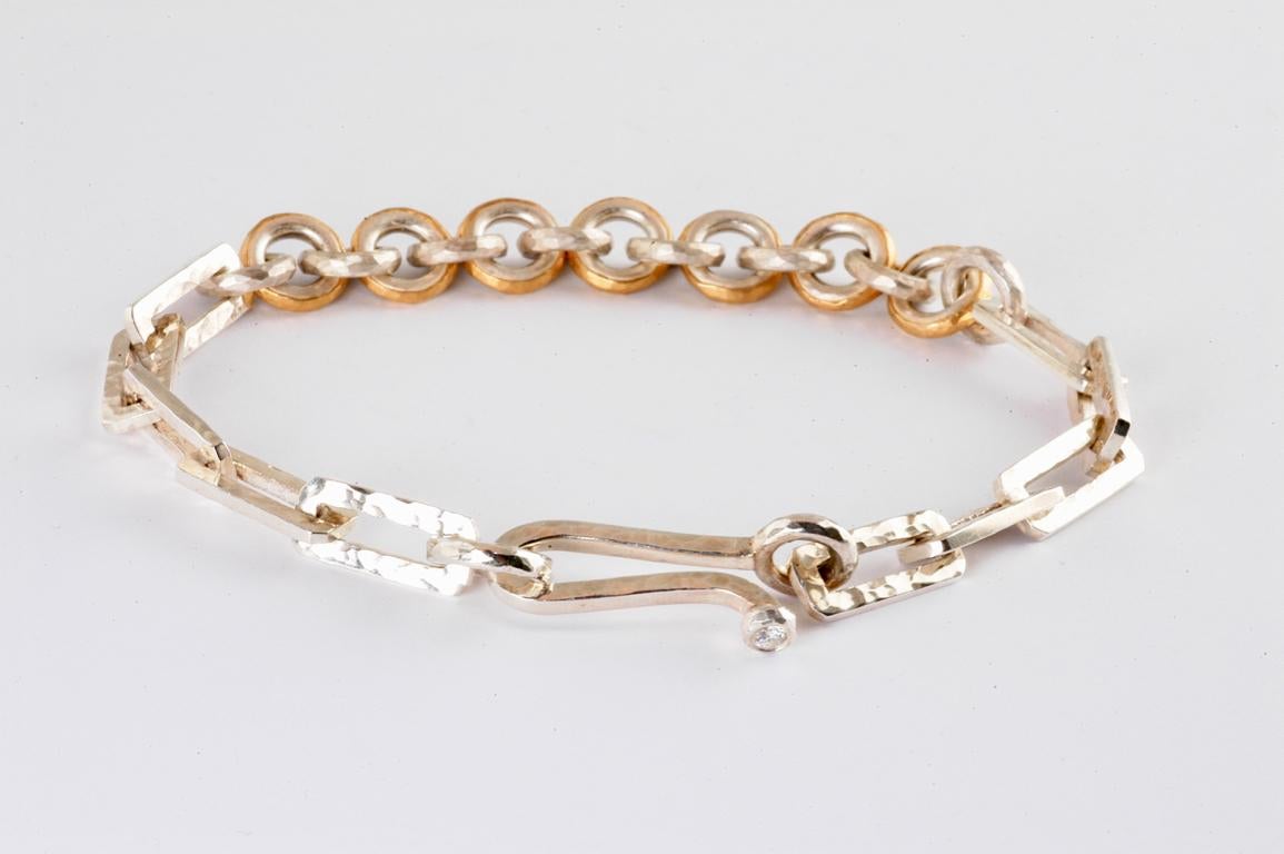 silver and 22k gold multi shape link bracelet hand made in Notting Hill, London by British jeweller Malcolm Betts.   22k gold is forged onto the round silver links to create contrast, alongside the rectangular hammered silver links. Each link is