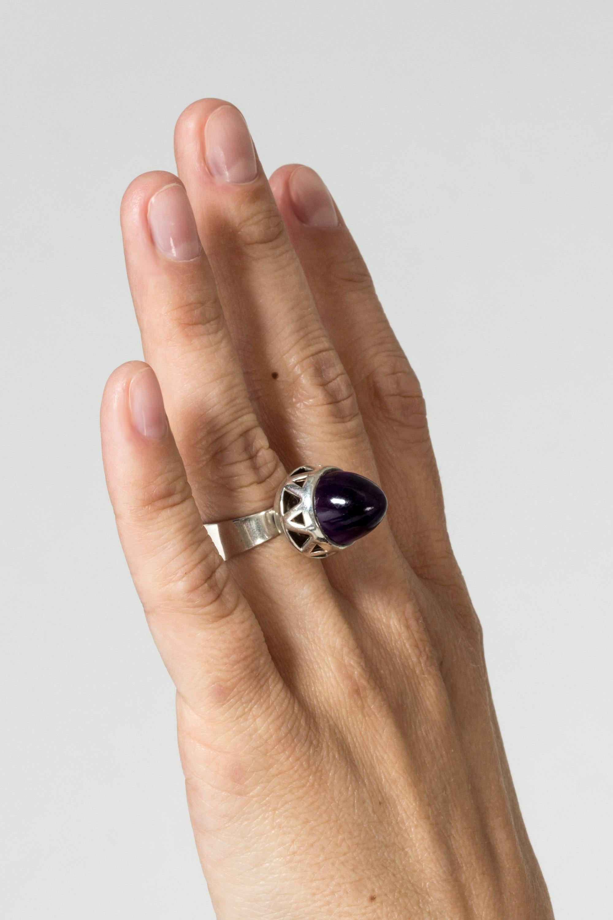 Very cool silver ring from Bengt Hallberg, with a large, pointy amethyst stone. Cutout setting that lets light in from under the stone and gives it an inner glow.