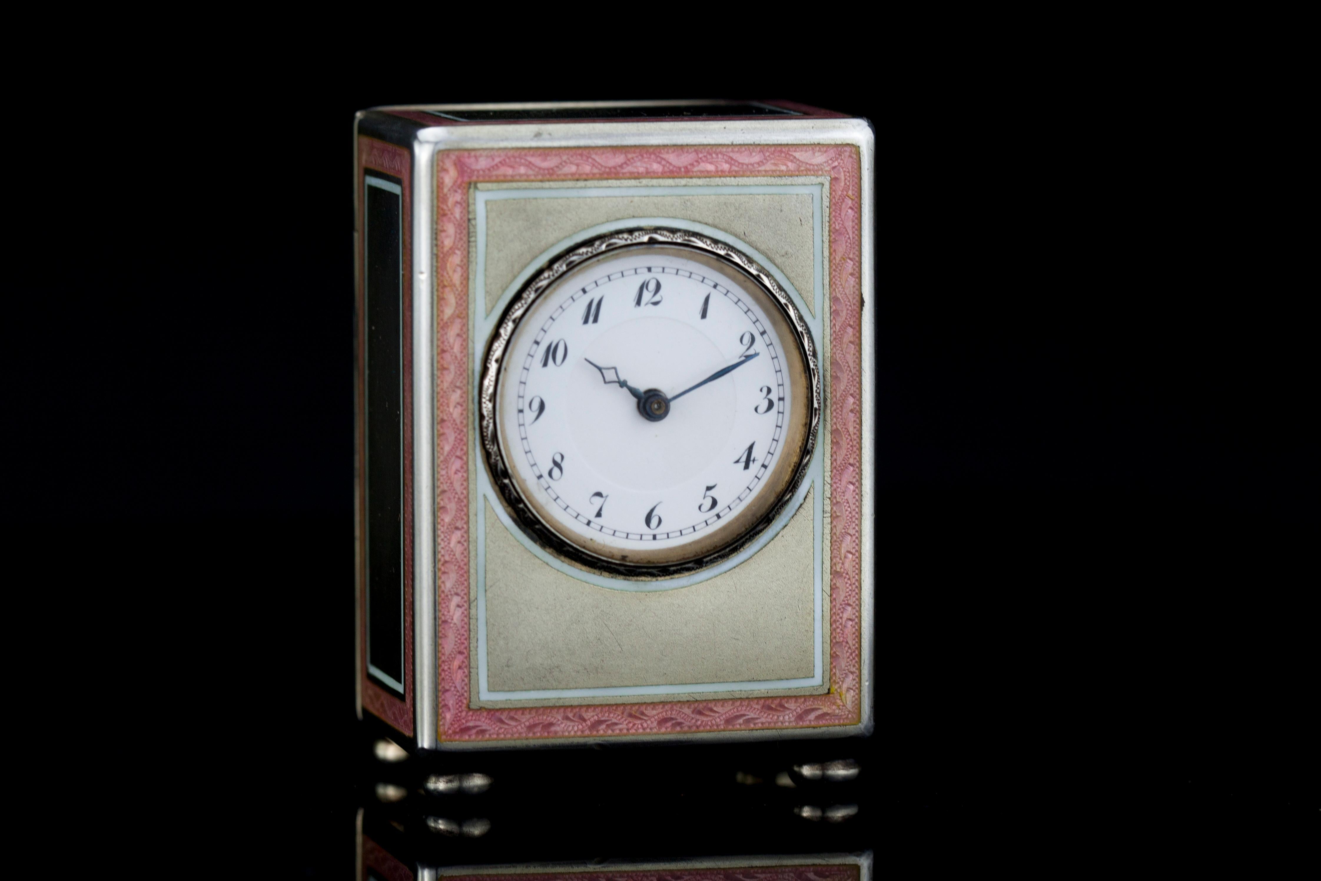 A very fine silver and blue guilloche enamel sub miniature carriage clock in its original case. The superb enamel in mint condition and is on four sides including the top. The engine turning is all in a sunburst design. The clock stands upon bracket
