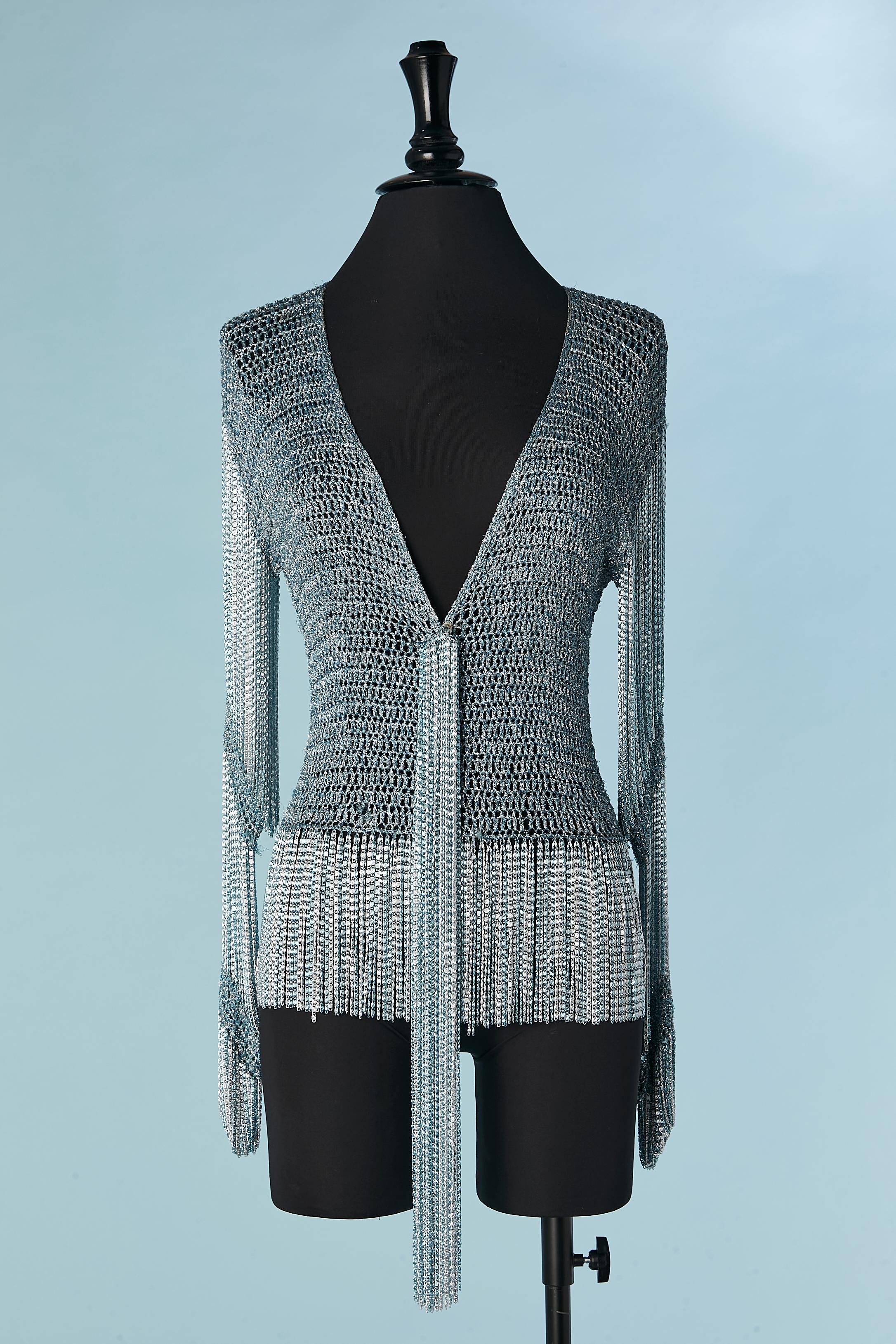 Silver and blue lamé knit and metal chain cardigan. 
The iconic Loris Azzaro top was owned in differents colors by both Tina turner and Audrey Hephburn. This one is a blue and silver lurex knit bodice with long chain tassel down the front , hiding