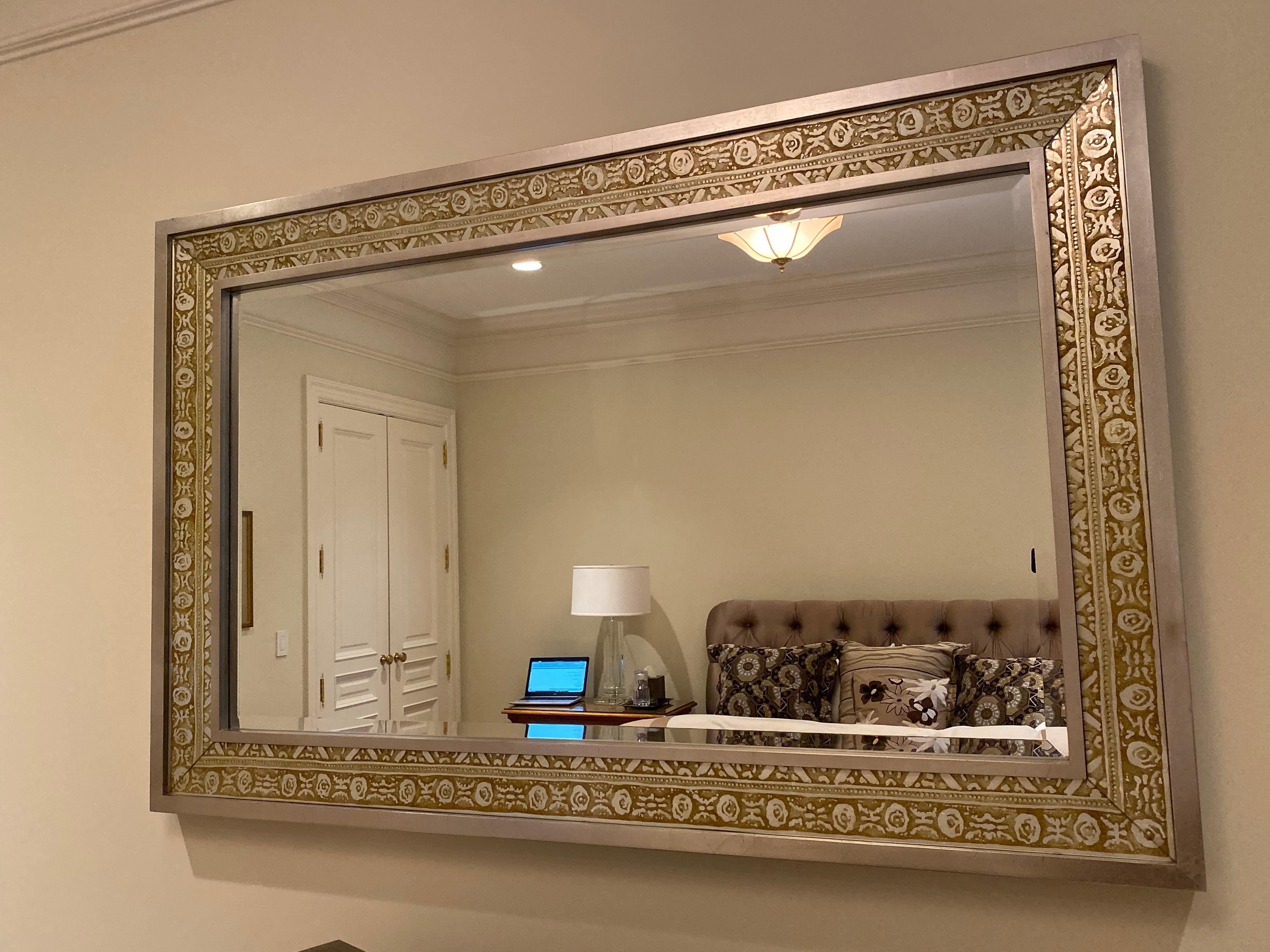 Beautiful and delicate detail of silver and bronze frame this substantial wall mirror.
Hang horizontally as we did or vertically in a bathroom or hallway.
Measures: 70