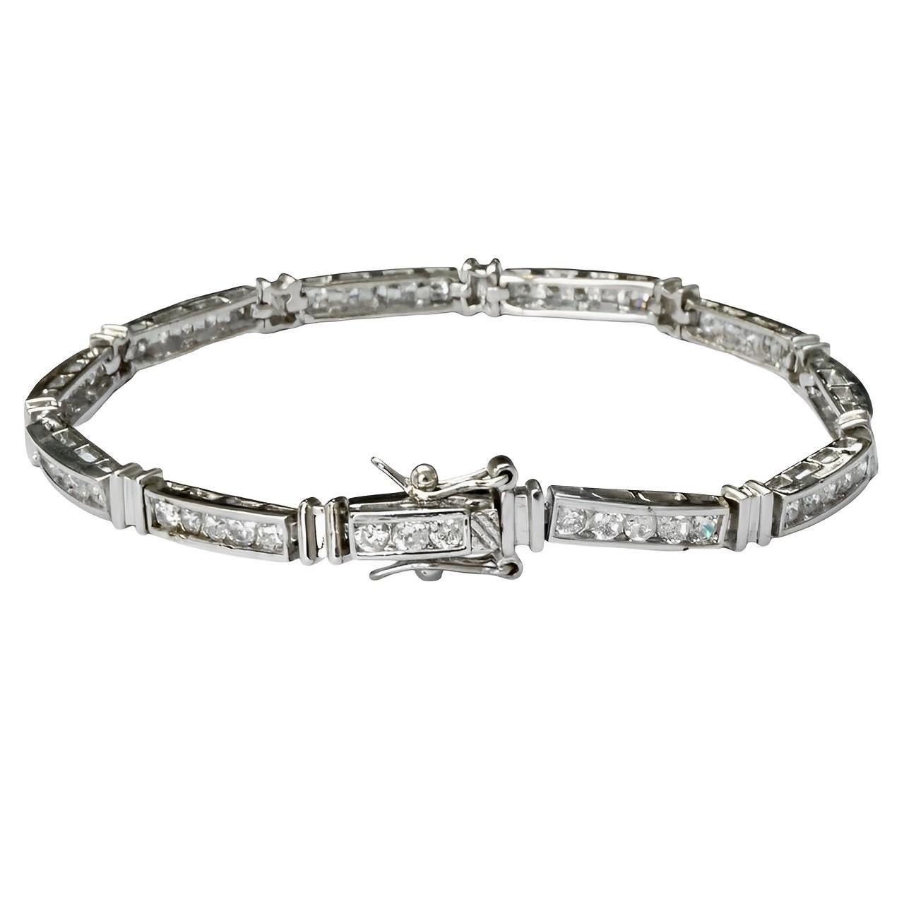 Beautiful silver link bracelet with double safety catches, featuring five channel set rhinestones in each link. Measuring length 19.4 cm / 7.6 inches by width 3.5 mm / .13 inch. The bracelet tests for silver, and is in very good condition.

This