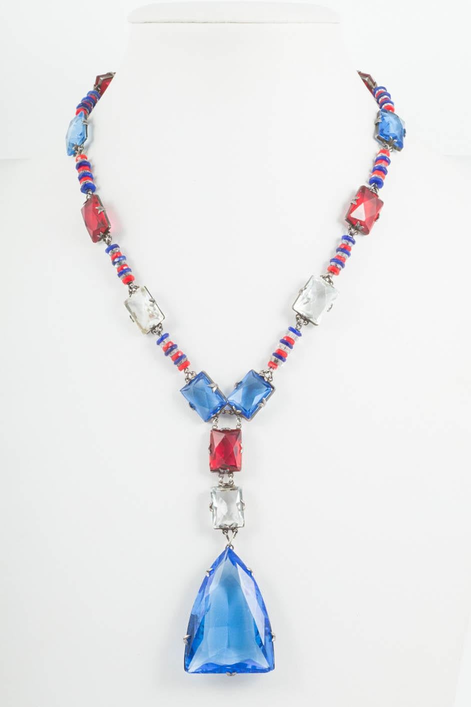 A stylish sautoir necklace , with red, blue and clear glass of assorted shapes and sizes, all hand set in silver, made in France, during the Art Deco years. A classic, timeless necklace, highly wearable, through all seasons.
