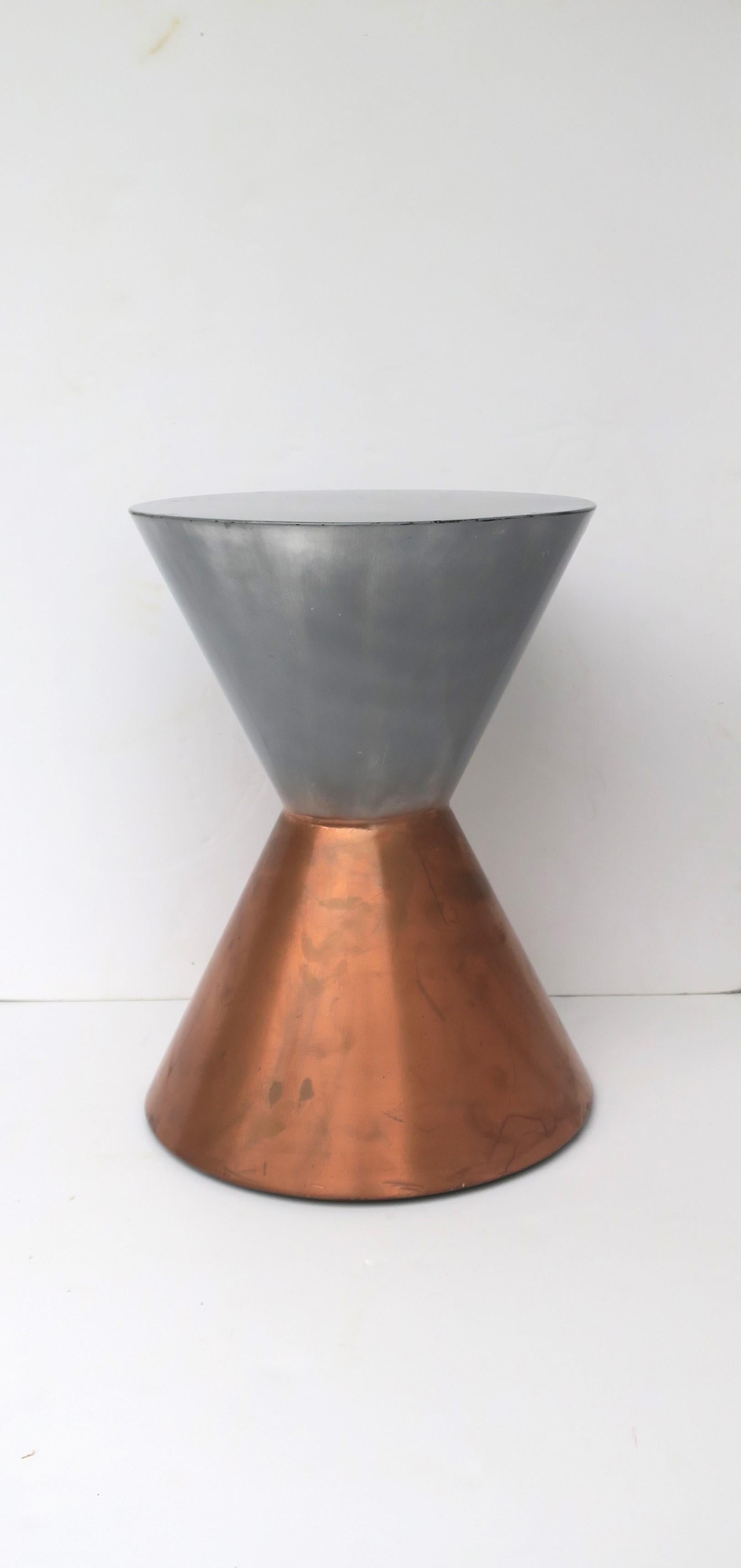 A substantial silver and copper hued hourglass side drinks table, circa late-20th century. Table has a weighted base for stability. A great table for drinks, cocktails, etc. Piece is a convenient size. Dimensions: 15