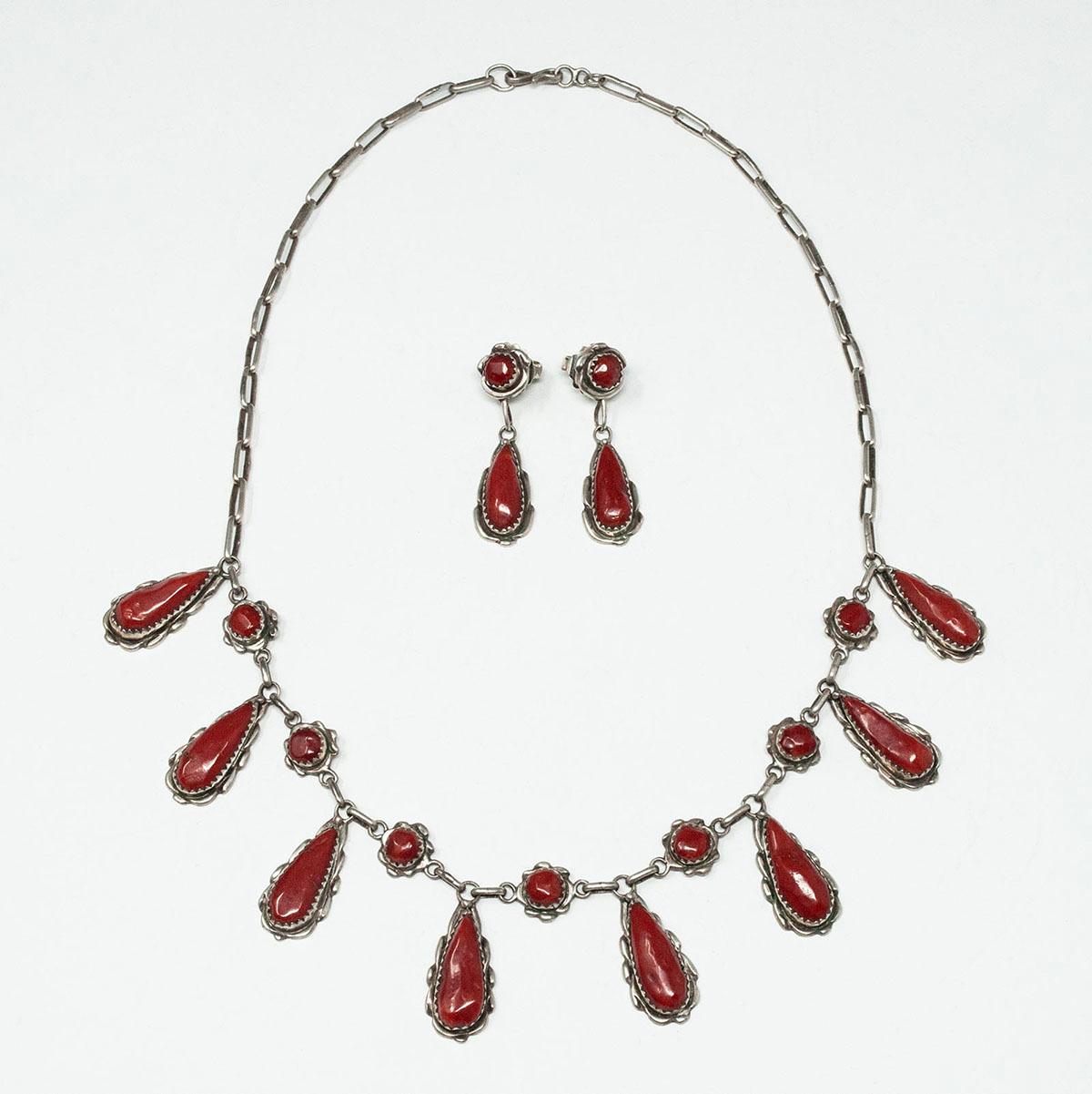 Silver and Coral Necklace and Earrings by Alvina Quam, Zuni jeweler

An elegant necklace created by Alvina Quam, the daughter of Alice Quam, a renown Zuni jeweler. Eight coral cabochons are set in beautifully crafted silver bezels, which are placed