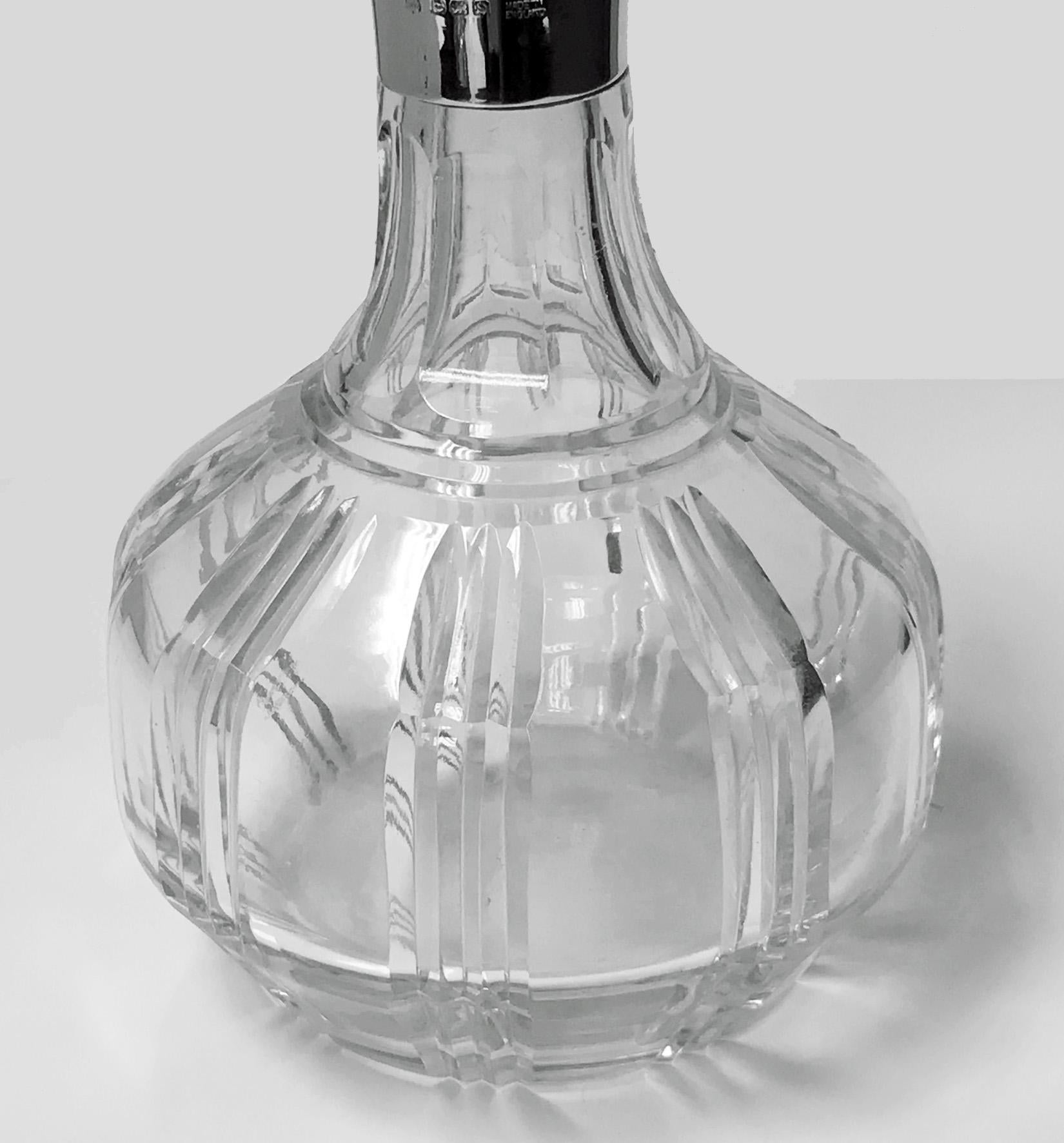 Sterling silver and handcut crystal Decanter Birmingham 1942, Barker Bros Silver Co. The decanter of bulbous shape, plain and inter spaced with handcut fluted ribbed sections surrounds, silver collar with lip, and original fluted stopper. Made by