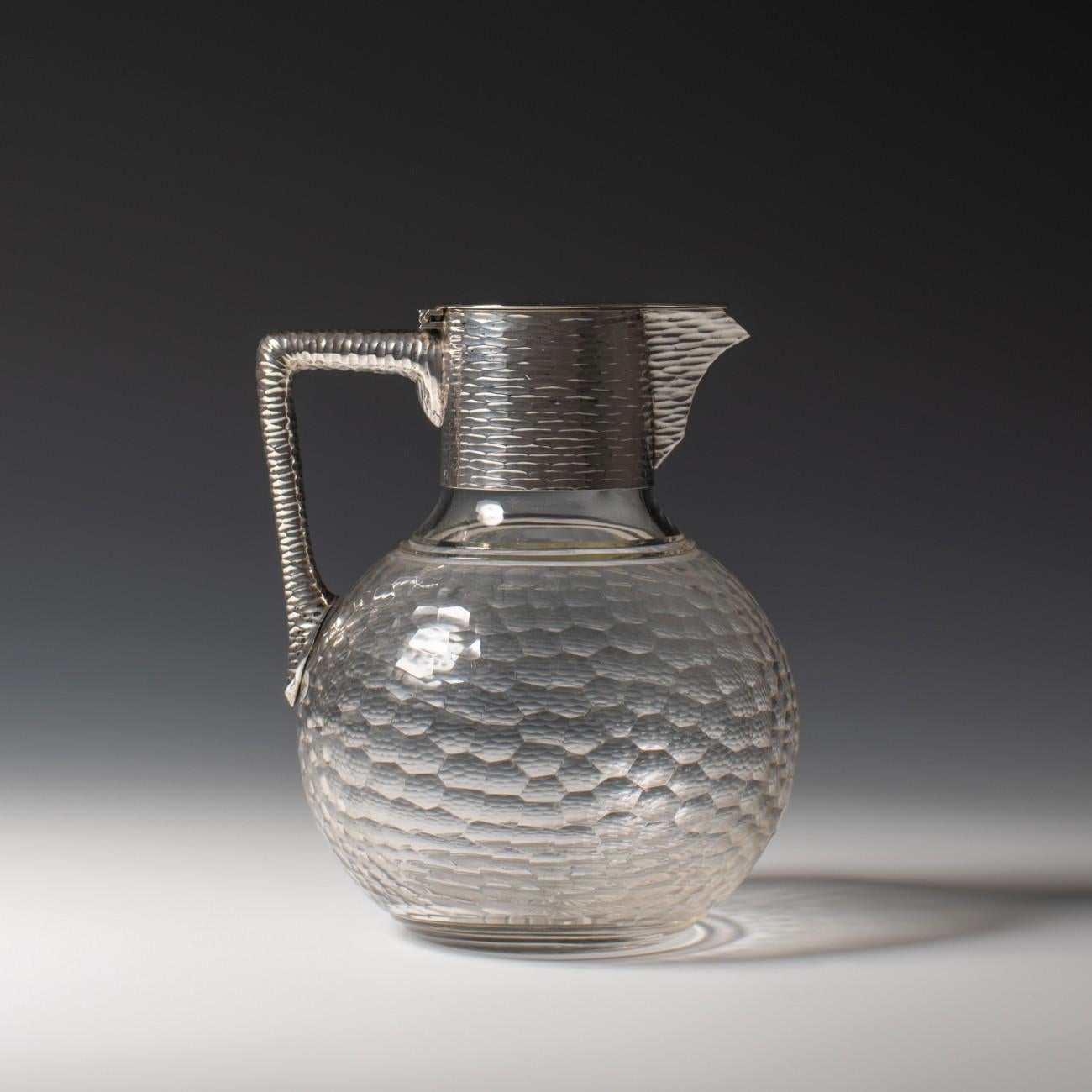 A stylish Austrian faceted cut glass and textured silver claret jug with 800 silver mark for Vienna, circa 1900 and makers mark for the workshops of Brüder Franks. Lovely quality.

Dimensions: 12.5 cm/4? inches (diameter) x 16 cm/6¼ inches