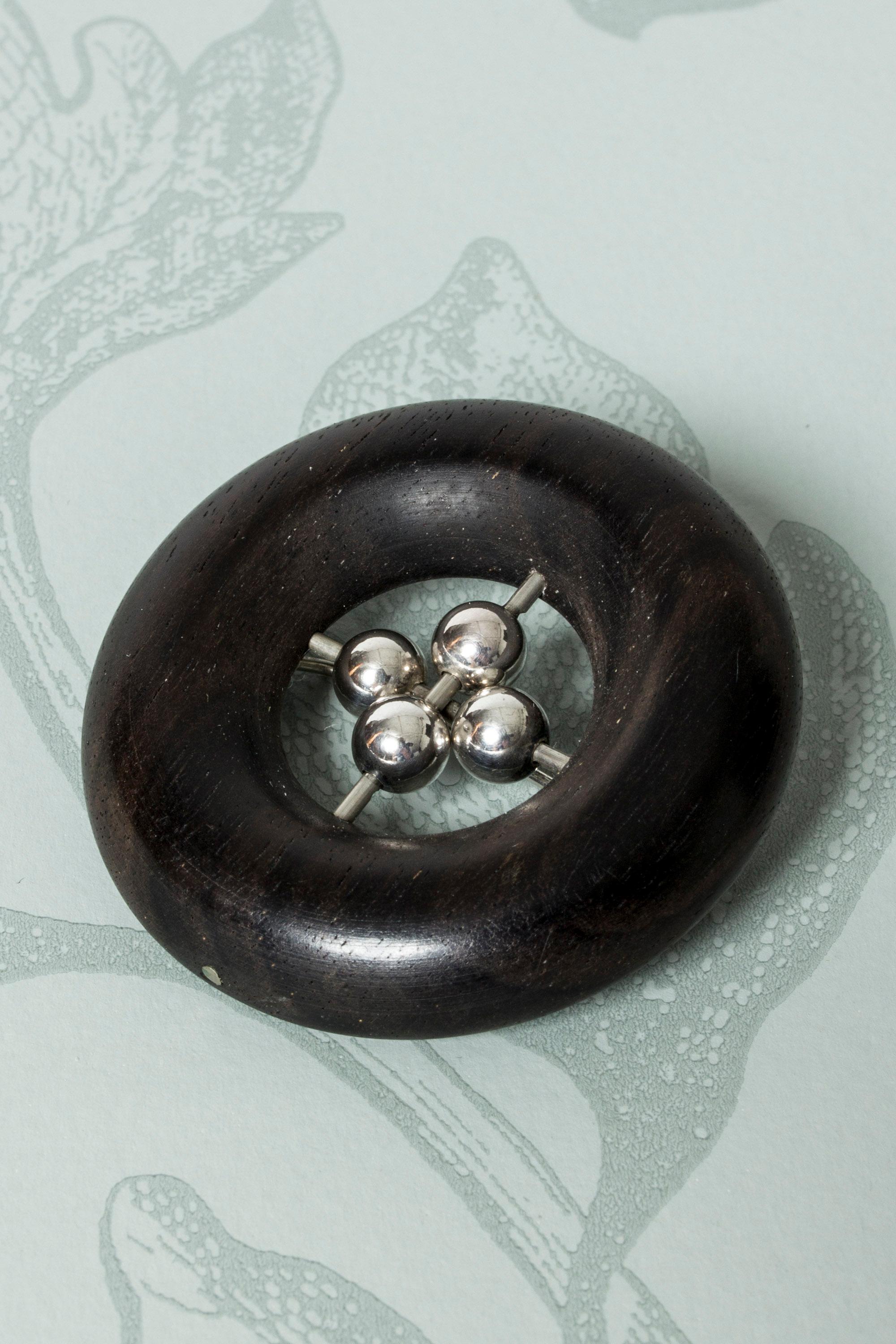 Silver and ebony brooch from Aarikka, in a clean design with an appealing swell to the ebony ring. Cool, graphic look.
