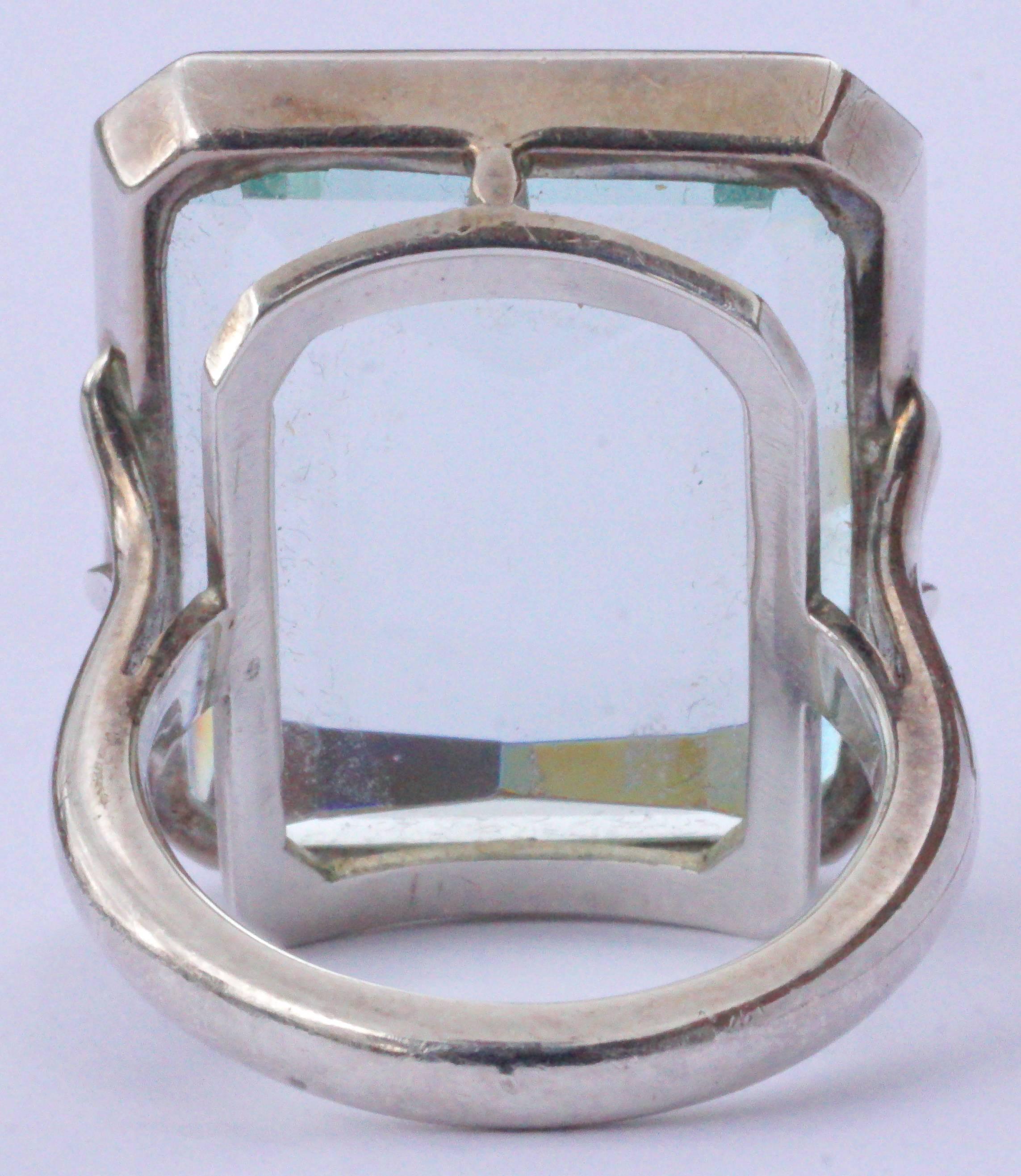 Vintage silver ring with a large emerald cut glass stone, ring size UK L, US 5 1/2 (inside diameter 1.7cm, .67 inch), and weighing 10.6 grams. The beautiful pale aqua glass stone measures 2.2cm, .86 inch, by 1.8cm, .7 inch, and is held with claws in