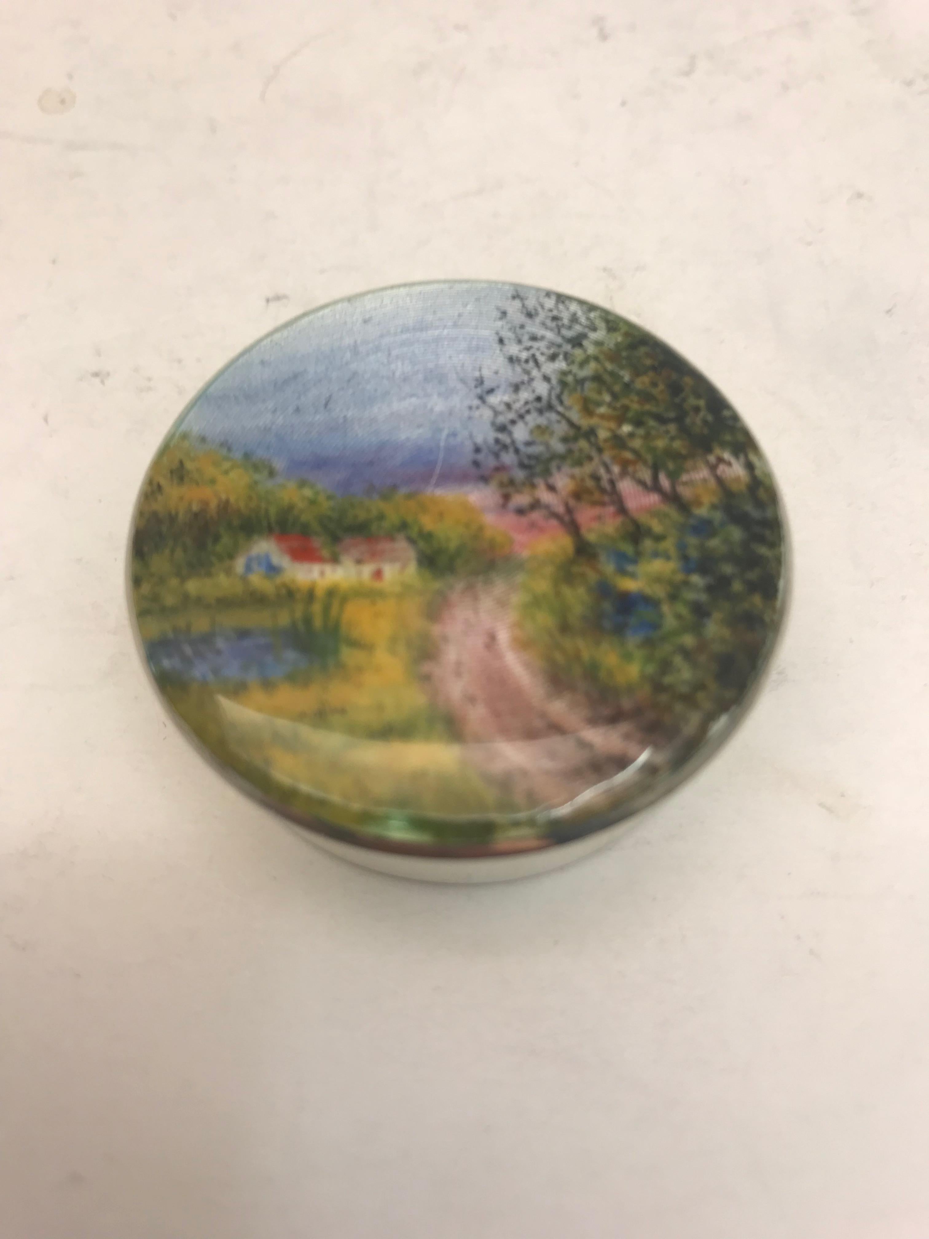 A small sterling silver and enamel box with country scene on lid made by H C Davis in 1924.
 