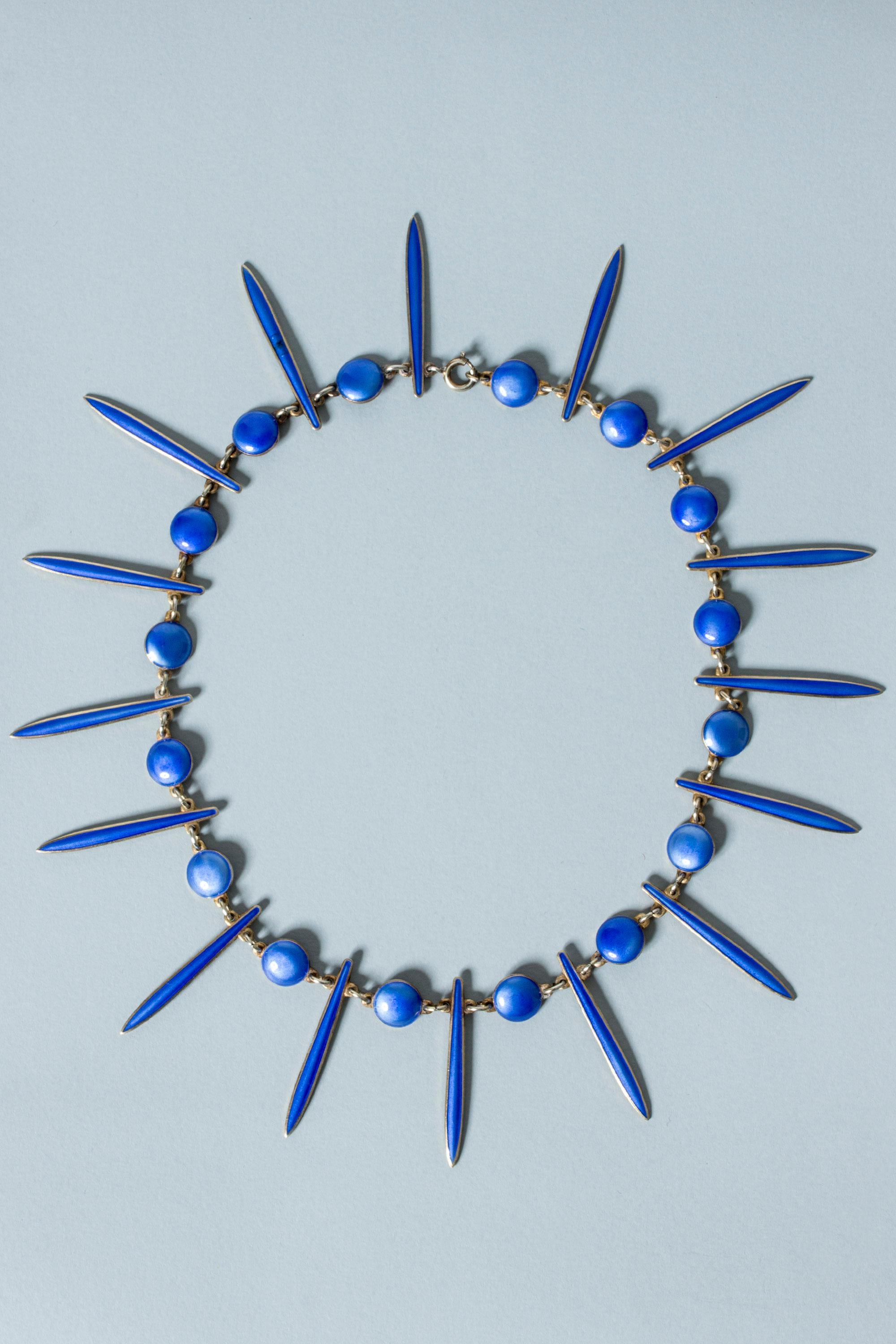 Striking silver collier from David Andersen, gilded with vibrant blue enamel. Circles alternate with long, thin leaves.