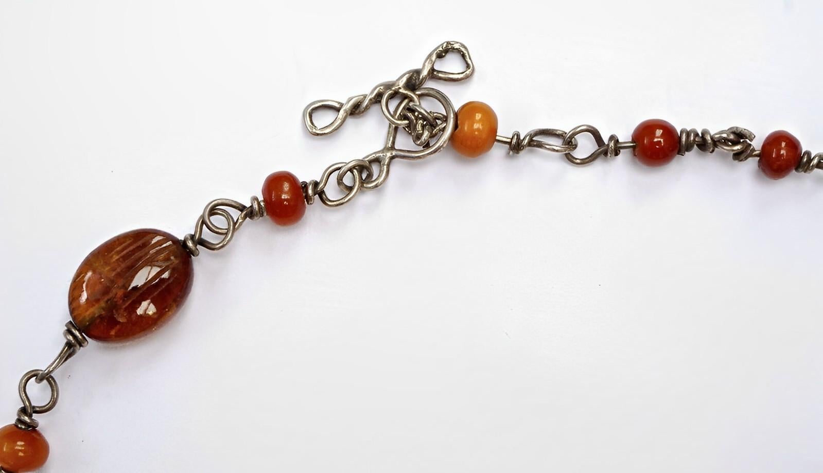 Wonderful silver necklace with floral etched amber beads, and a toggle clasp. There are no hallmarks, the necklace tests as silver. Measuring length 46.5cms / 18.3 inches. The largest beads are approximately 1.6cm / .63 inch by 1.2cm / .47 inch. One
