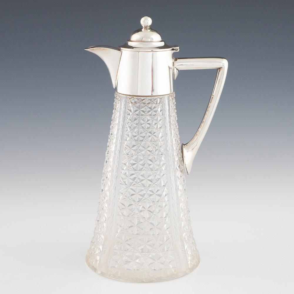Heading : Silver and glass claret jug George V
Date : Hallmarked in Sheffield in 1913 for Travis, Wilson & Co
Period : George V
Origin : Sheffield, England
Colour : Clear glass and silver
Body : Tapered form with panels cut in the ‘Russian Pattern’