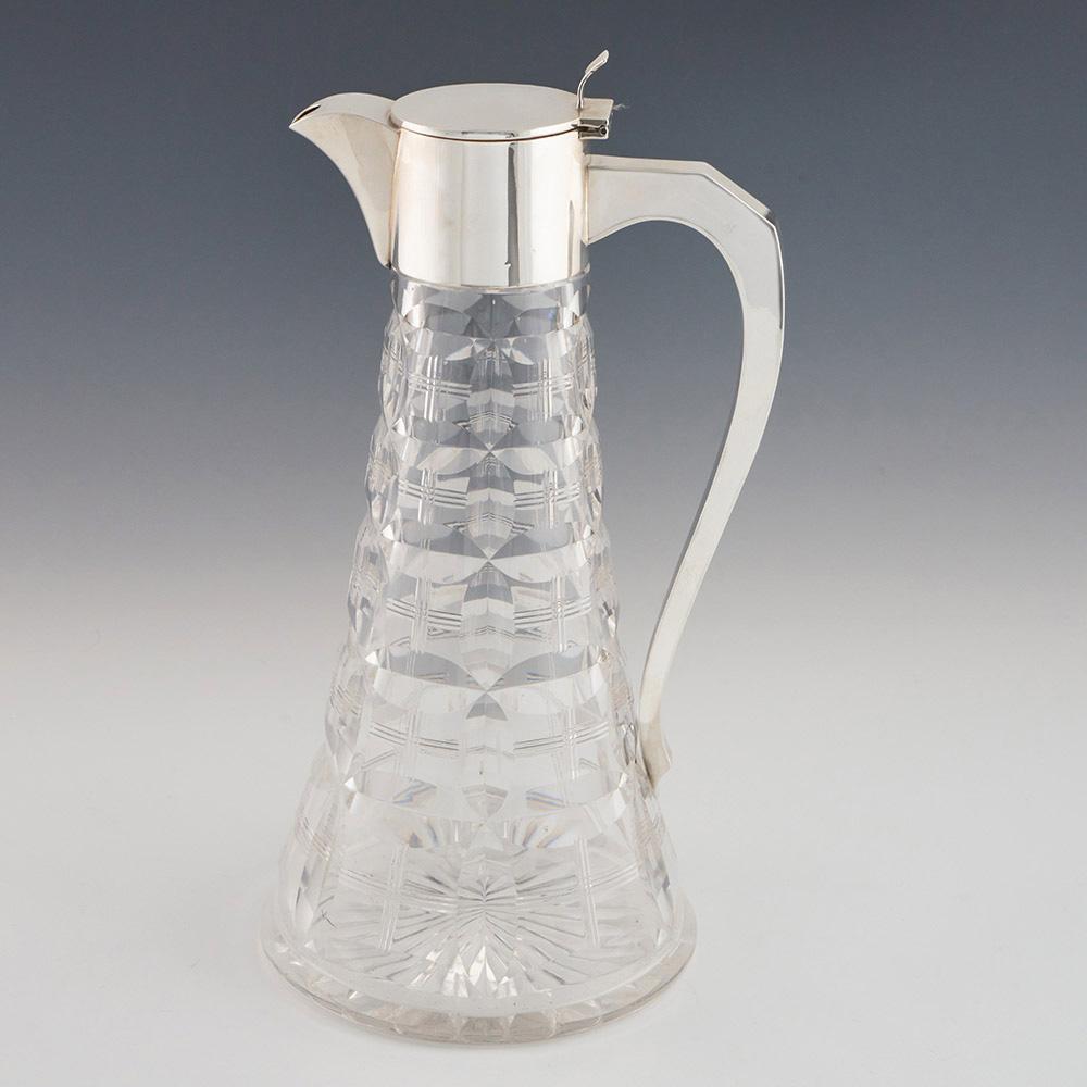 Heading : Silver and glass claret jug Walker and Hall 1926
Date : Hallmarked in Sheffield in 1926
Period : George V
Origin : Sheffield, Yorkshire, England
Colour : Silver and clear glass
Decoration : Vertical and horizontal split cut ovals with