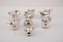 Silver and glass mustard pots. England, 20th century.