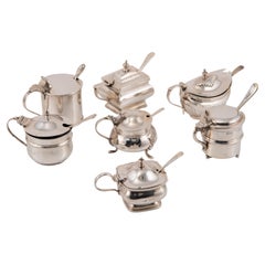 Silver and glass mustard pots. England, 20th century.