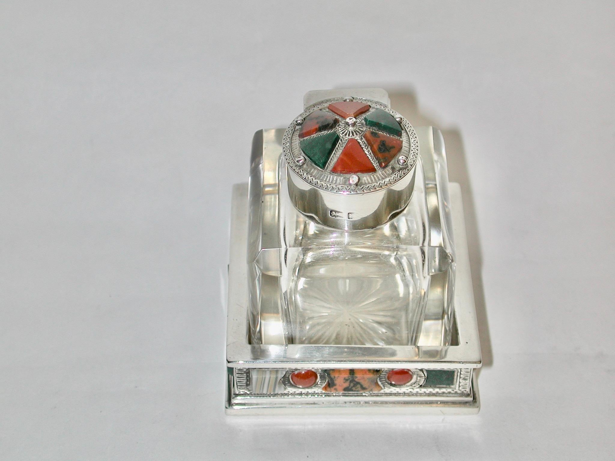 Silver and Glass Scotch Pebble Inkpot dated 1902 James Fenton Birmingham
The relief of the scotch pebble is quite pronouced and is on every side of 
the square base as well as the lid
The Silversmith has made use of banded