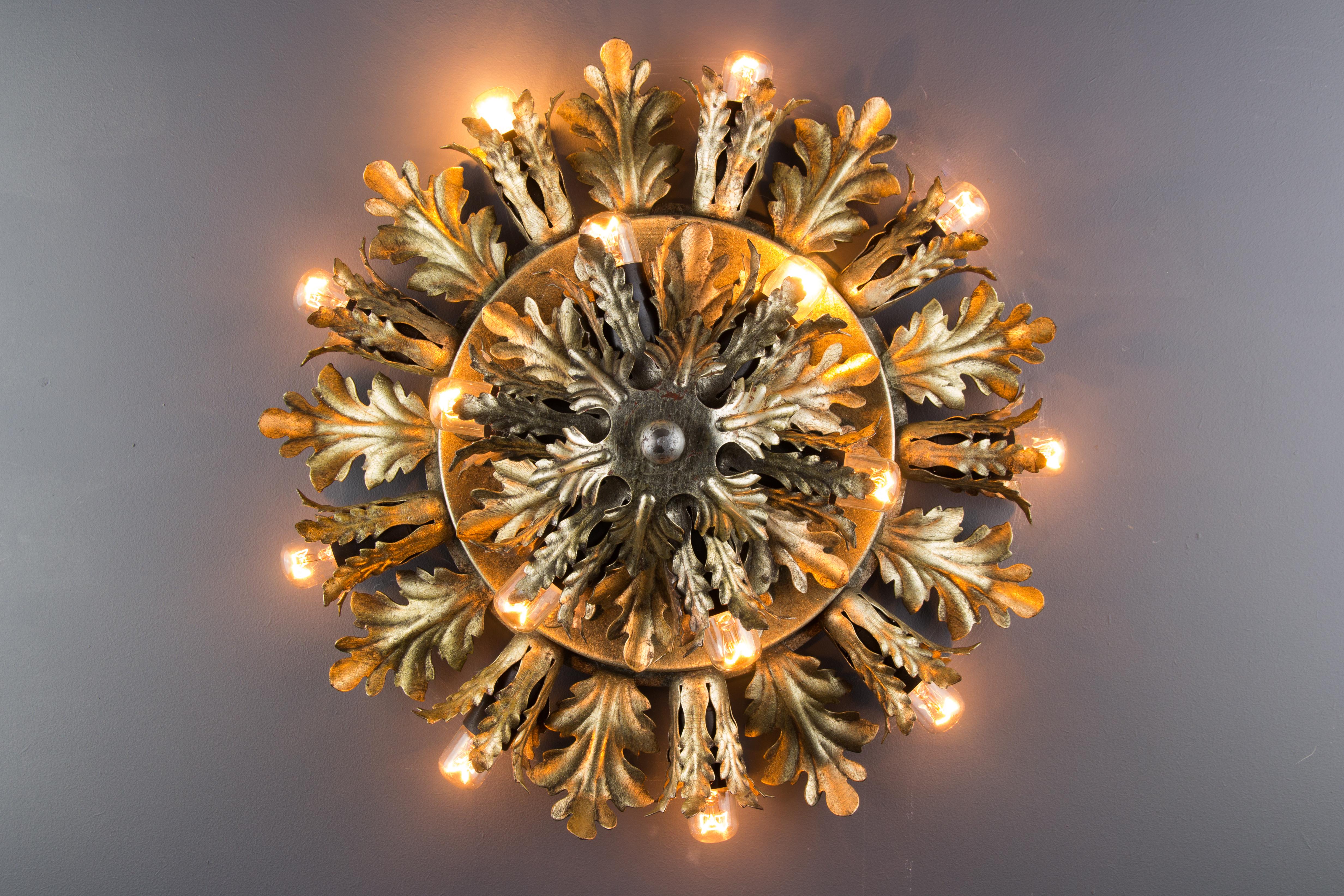 This beautiful fifteen-light ceiling lamp features oak leaves arranged in the shape of a sunburst and is patinated with gold- and silver-color accents. Italy, the 1950s.
It can be used also as a wall lamp.
Fifteen sockets for E14-size light