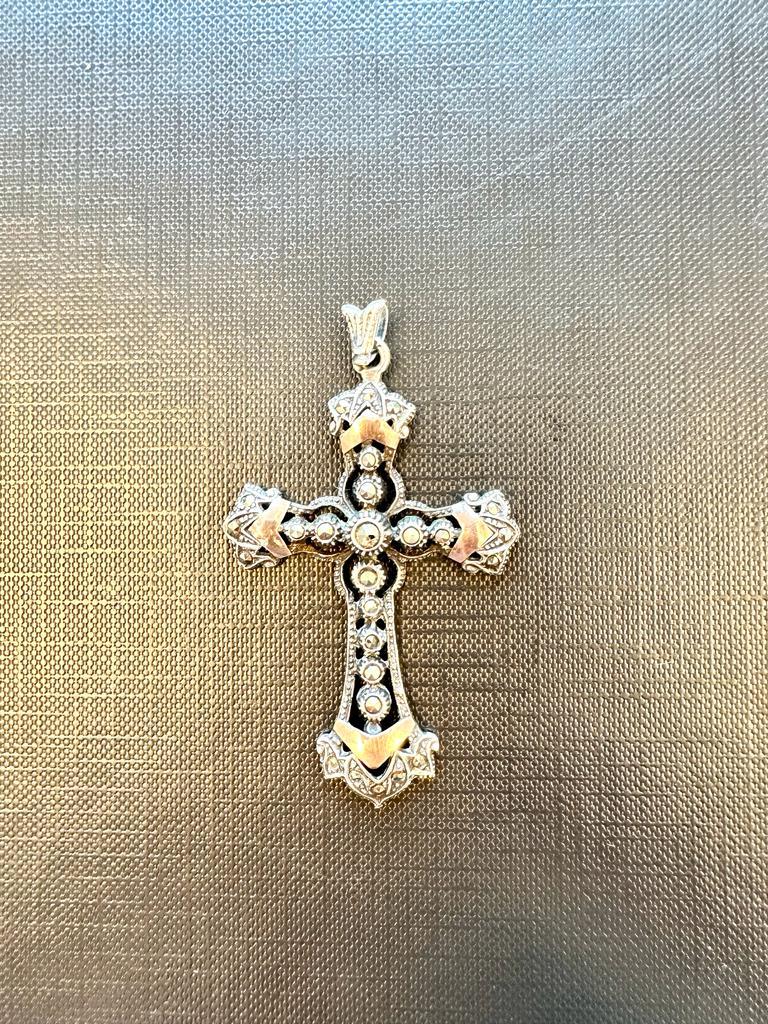 This beautiful cross in silver and gold is a rare and very old piece. Handmade, this antique pendant is decorated with 26 Marcasites. 
The Marcasite is actually Pyrite in disguise and the name 