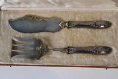 Silver and gold metal serving cutlery in their box