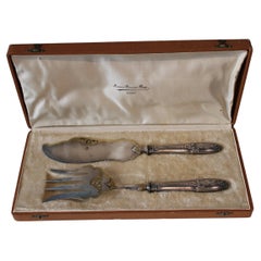 Silver and gold metal serving cutlery in their box