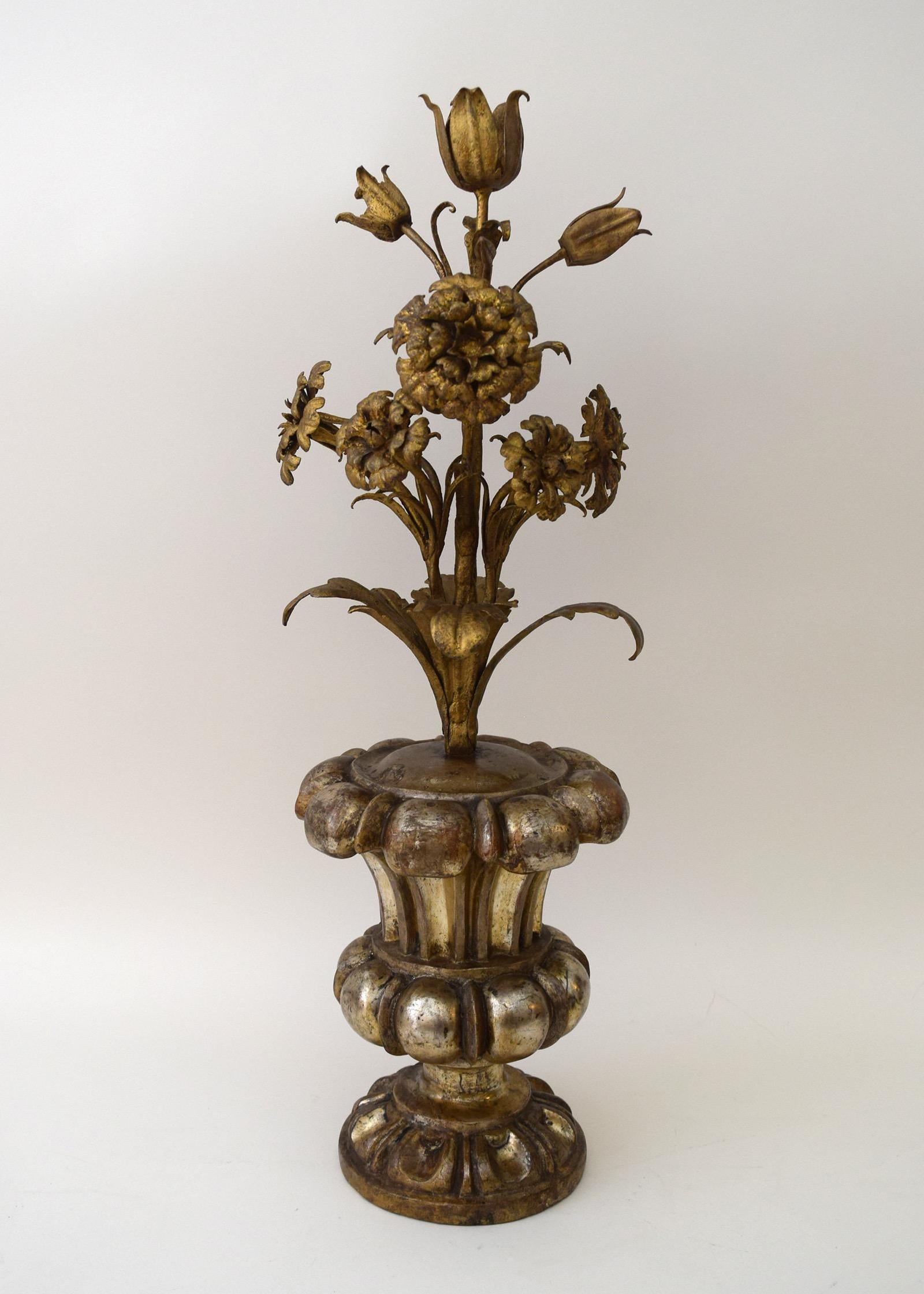 This flowering urn of gilt-metal flowers in a gessoed, silver-leafed urn was probably made in Genoa, Italy, circa 1715. If the flowers are carnations, symbol of the Virgin’s love for her Son, and lilies, symbol of the Immaculate Conception, it may