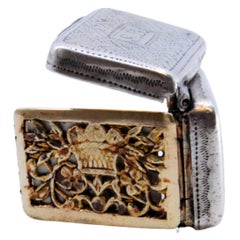 Silver and gold vinaigrette box with George III period engraving on the lid