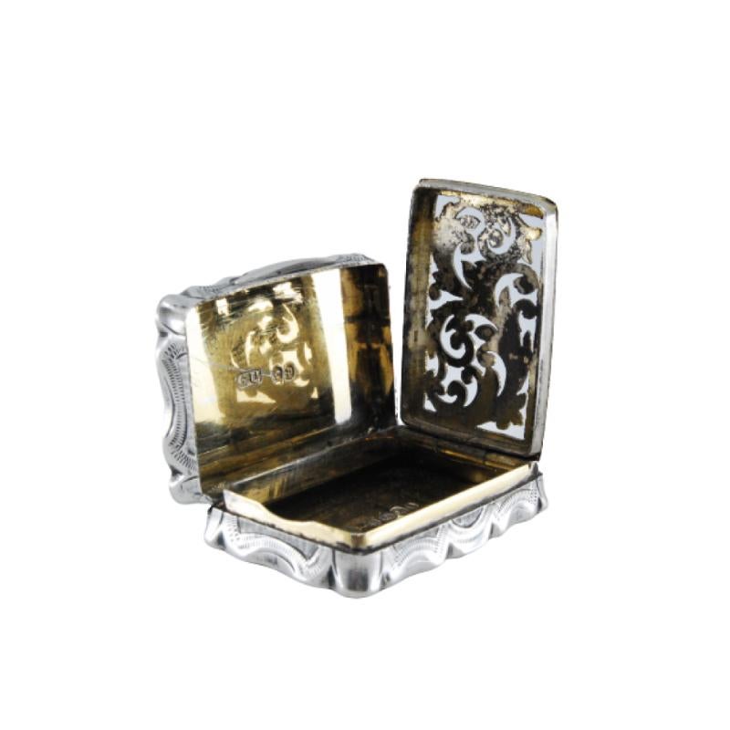 Silver and gold vinaigrette box with relief and shield on the lid