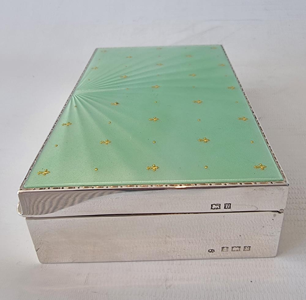Humidor per sigari o sigarette in argento Giorgio VI e smalto arabescato di Albert Carter, di buone dimensioni. Superbo smalto verde guilloché con fleur de lys in oro. Il motore girava, smalto guilloché a stelle e strisce, con coperchio a cerniera.