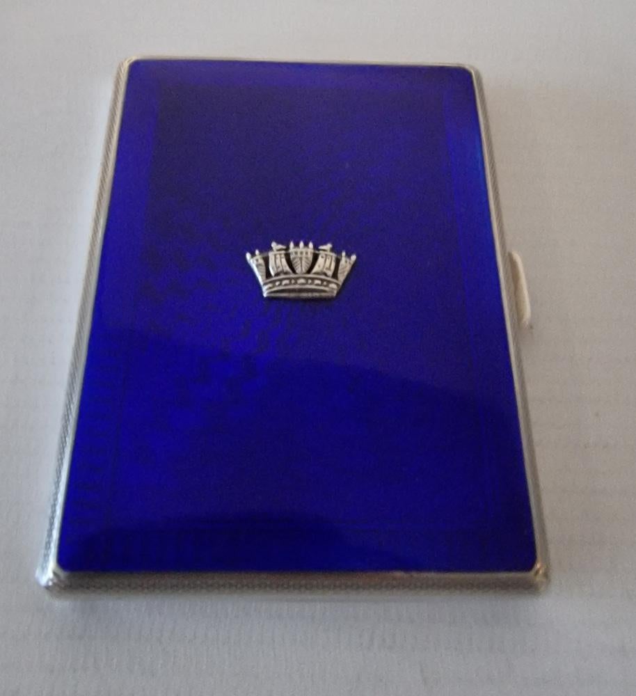 An attractive blue guilloche enamel cigarette or card case, the engine turned pattern, with crown marquesite atop the case. Gilded interior with elastic retainer. Hallmark for John William Barratt, Birmingham and date mark for 1935.