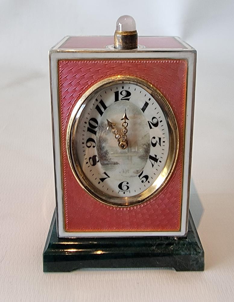 A stunning silver and pink guilloche enamel with white enamel border on a black agate base minute repeating miniature carriage clock. Extremely pretty pink on all four sides with fine engine turned patterns. The oval dial with silver gilt bezel and