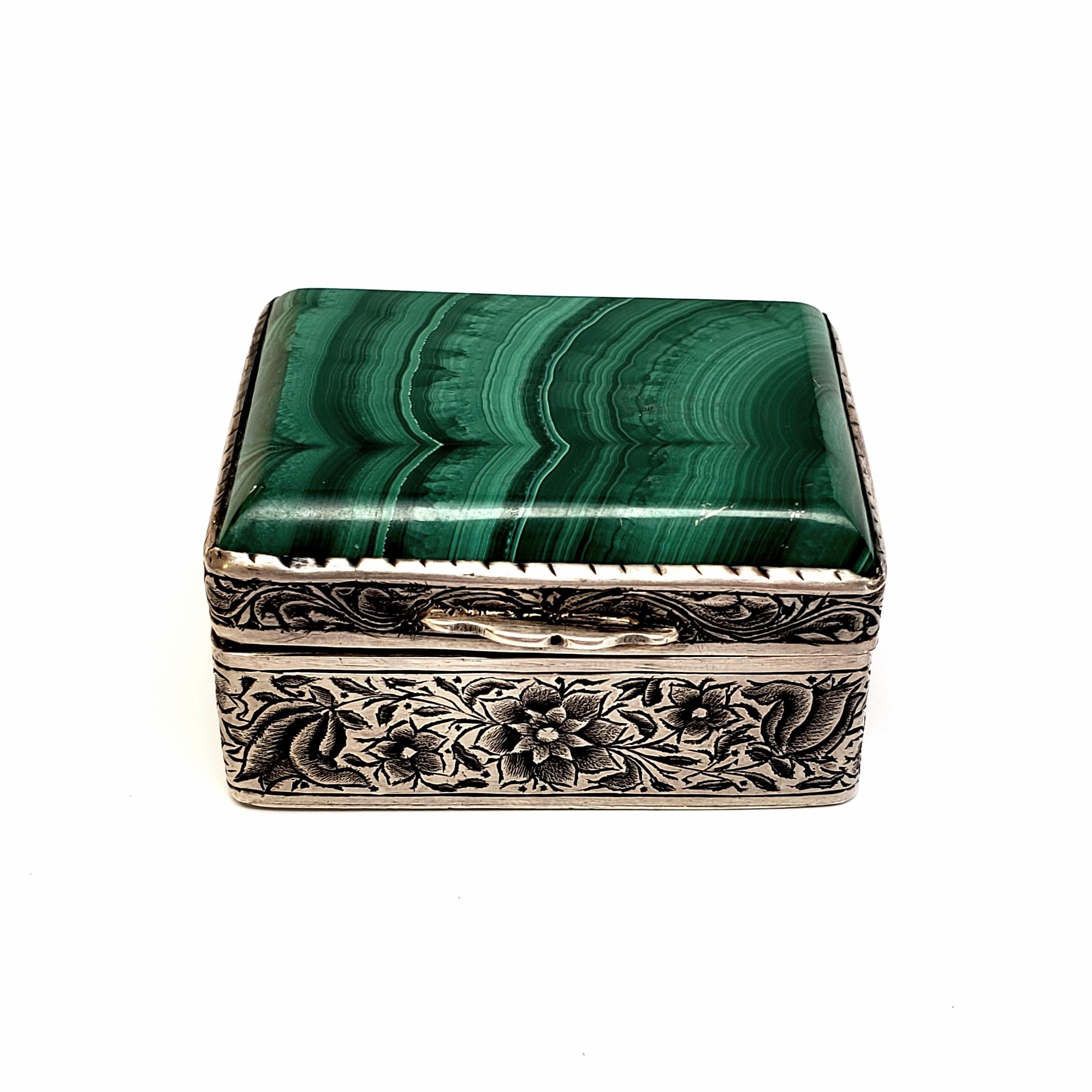 Etched silver trinket box with malachite lid.

Beautiful etched flower and leaf design all around the box. Gorgeous beveled malachite lid.

Box measures approximate: 1 7/8