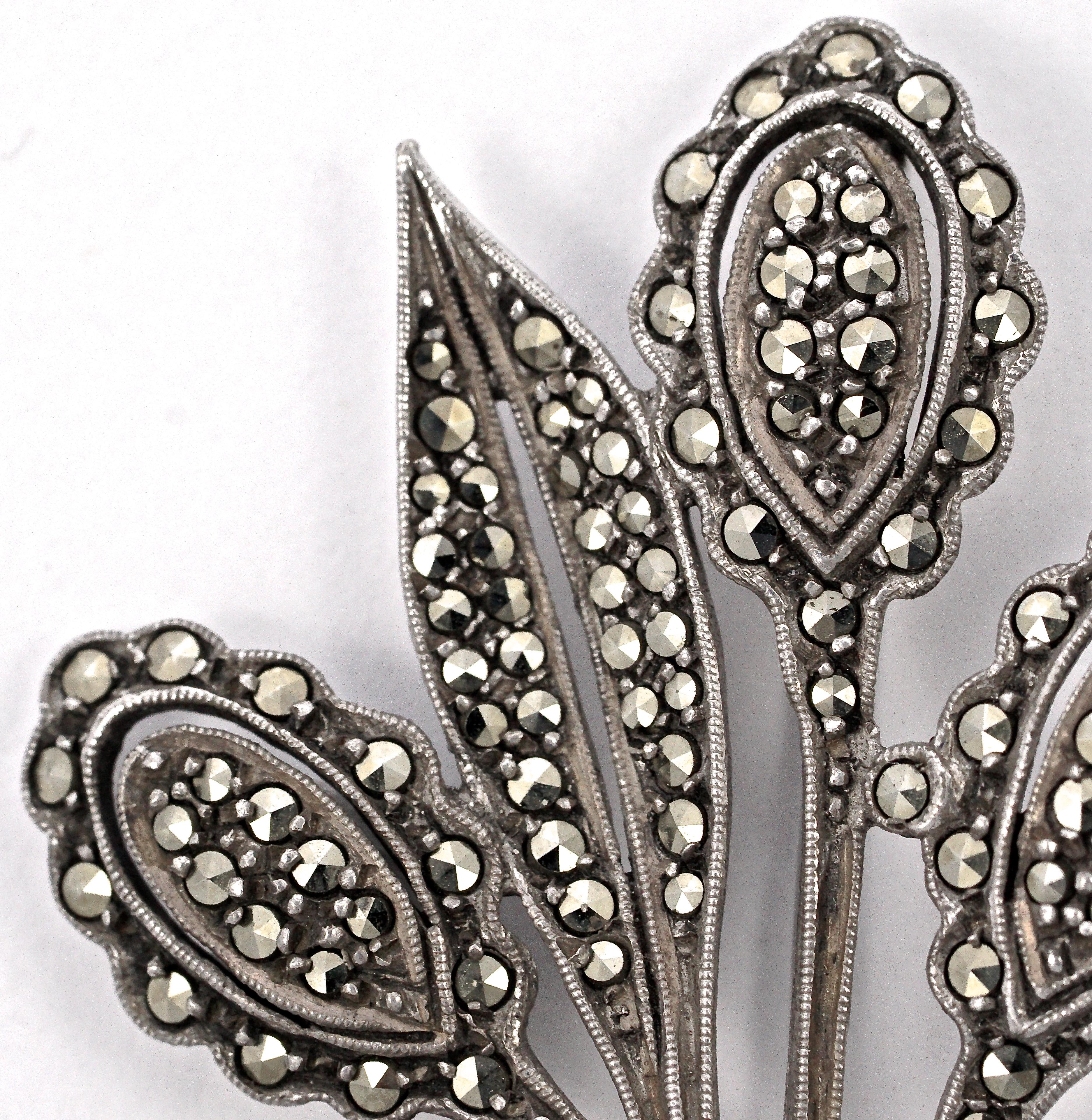 Beautiful silver brooch featuring a flower and bow design, and embellished with marcasites and silver decoration. Measuring length approximately 5.6cm / 2.2 inches by width 3.7cm / 1.46 inches. The brooch is marked 'SILVER' on the reverse and tests