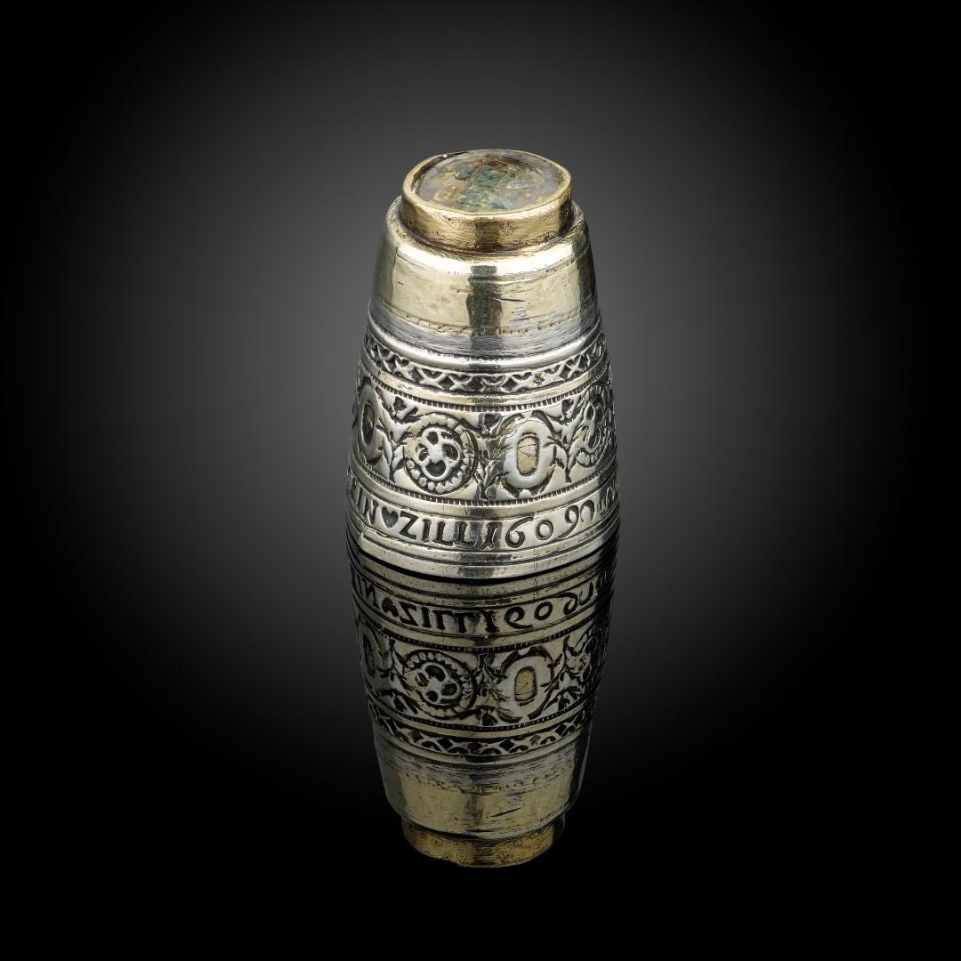 A very rare silver and parcel gilt Thimble, German, circa 1609, the base inset with an armorial carved in rock crystal. The side with motto “Wen Gott will Ist Mein Zill 1690” the piece would have had a detachable top now missing. There is an example