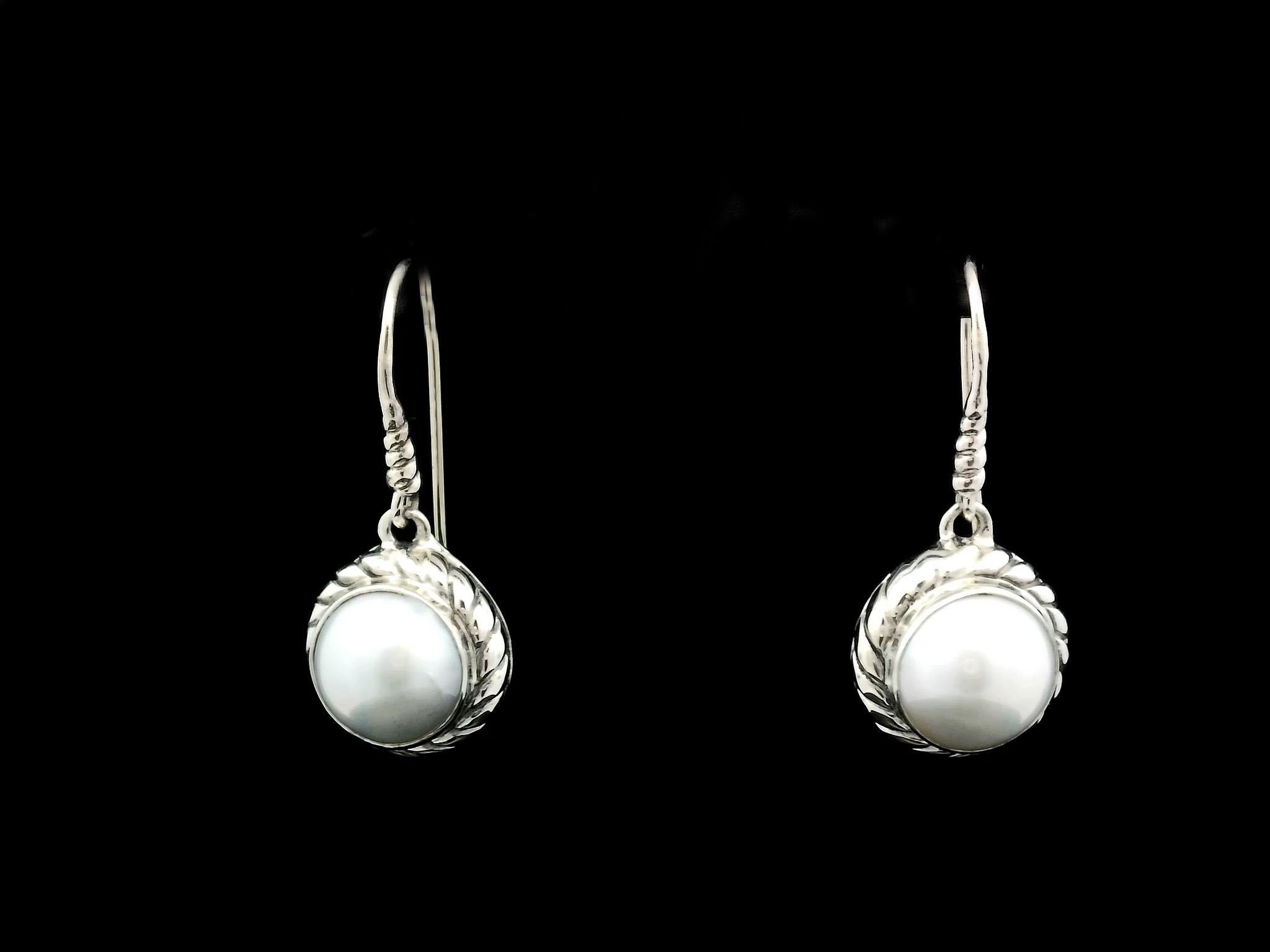 Silver Balinese handcrafted pearl drop earrings are exquisite pieces of jewelry that combine the artistry of Balinese craftsmanship with the elegance of pearls. Balinese silverwork is known for its intricate designs and attention to detail. Here's a