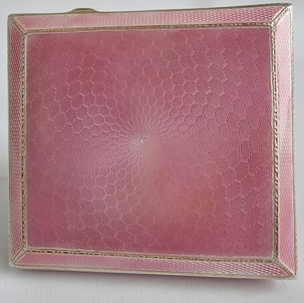 A most attractive and chic pink guilloche enamel and silver cigarette case. The fine engine turned pink guilloche enamel on all sides. The silver that can be seen to the outside is beautifully patterned. The interior is silver gilt. Hallmarked for