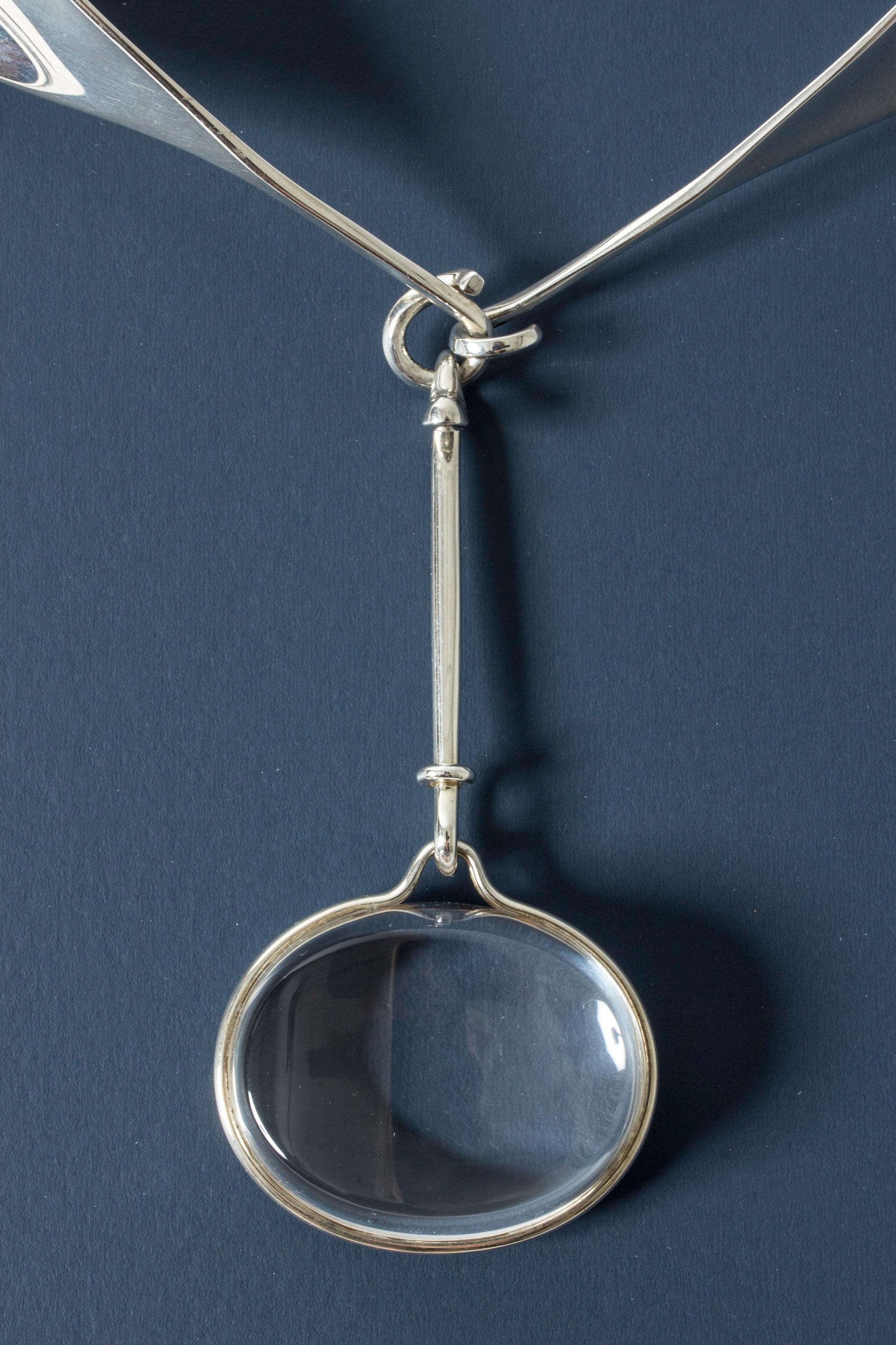 Stunning silver neckring by Torun Bülow-Hübe, with a wonderfully clear rock crystal pendant. The classic design with the wide, shawl-like neckring and the stone suspended like a large drop, lends indisputable elegance to its wearer.

Dimensions:
